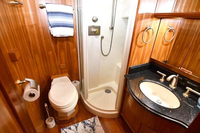 Luxurious bathroom in 2001 Symbol Raised Pilothouse Motoryacht with wood accents and modern fixtures.
