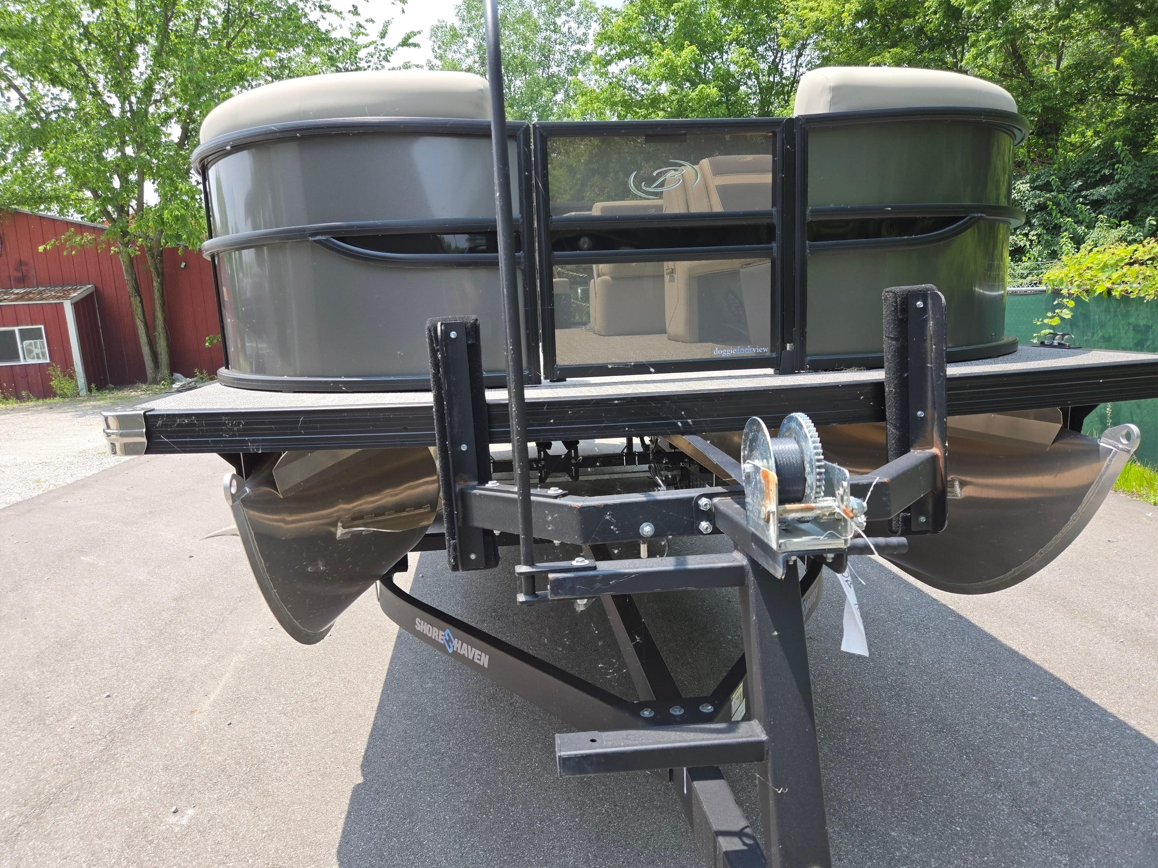 2023 Barletta Cabrio 24UE pontoon boat on trailer, parked outdoors.