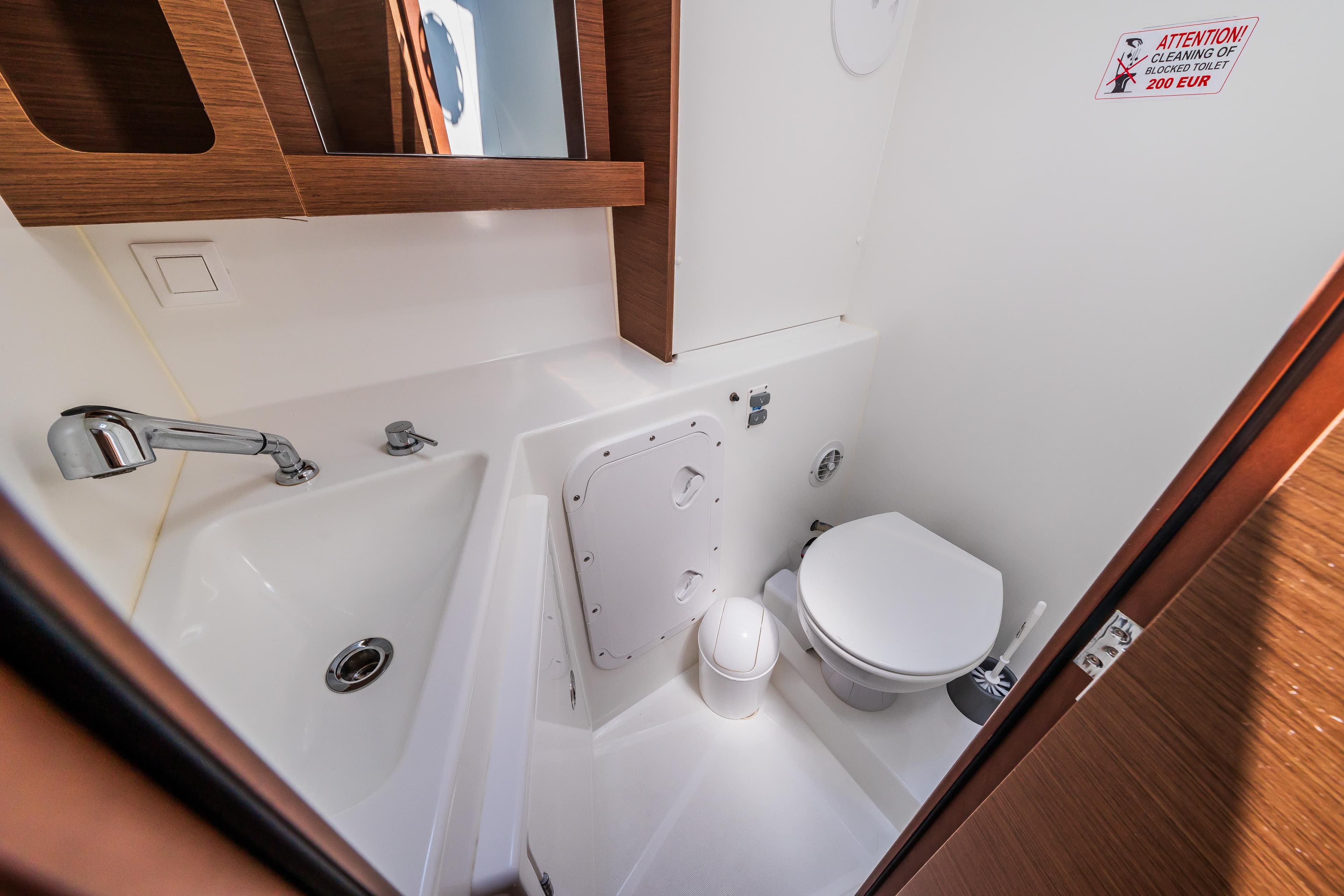 Compact bathroom in 2018 Lagoon 42 yacht with sink and toilet.