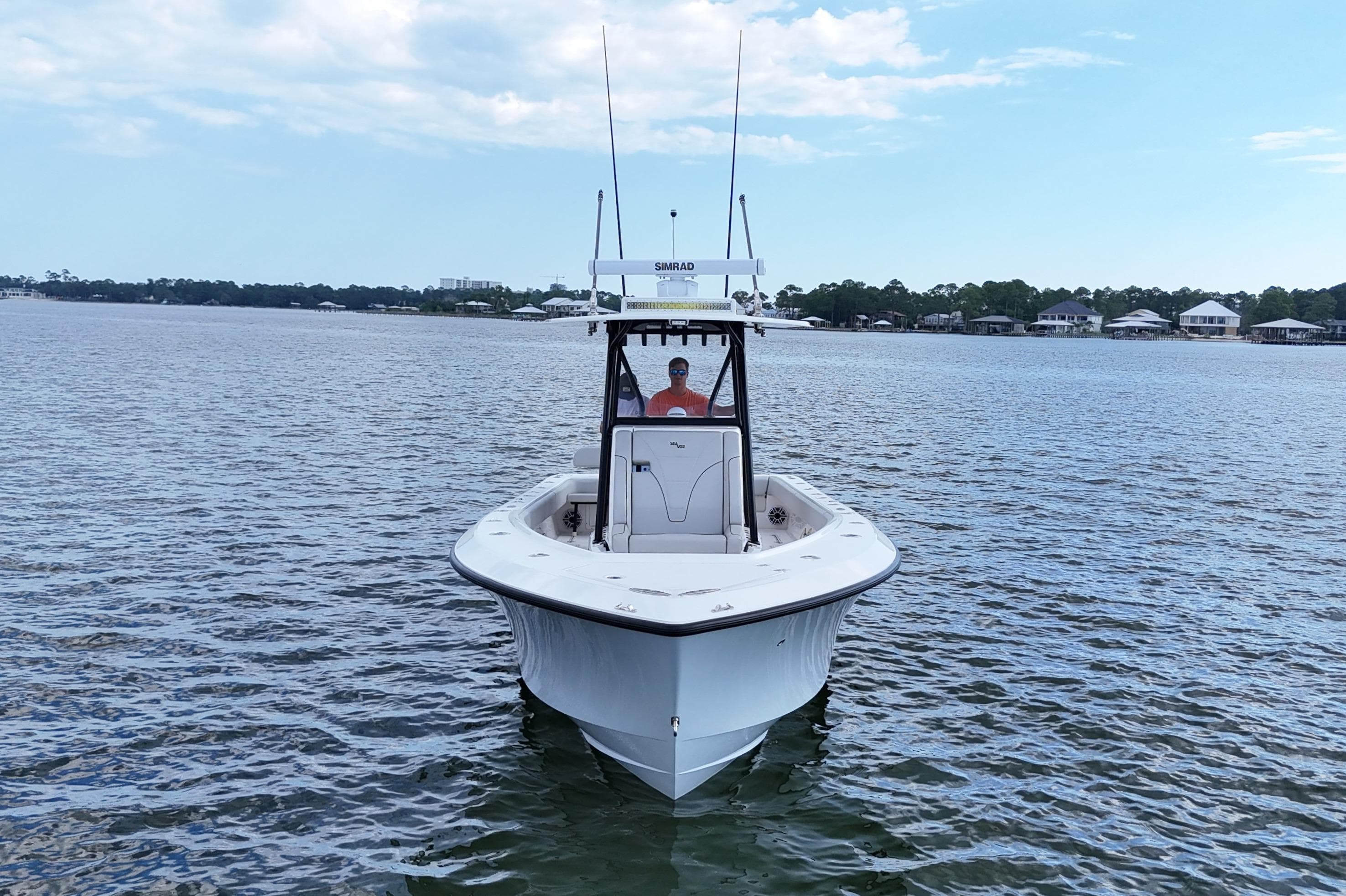 2023 SeaVee 32 boat on calm water under a partly cloudy sky.