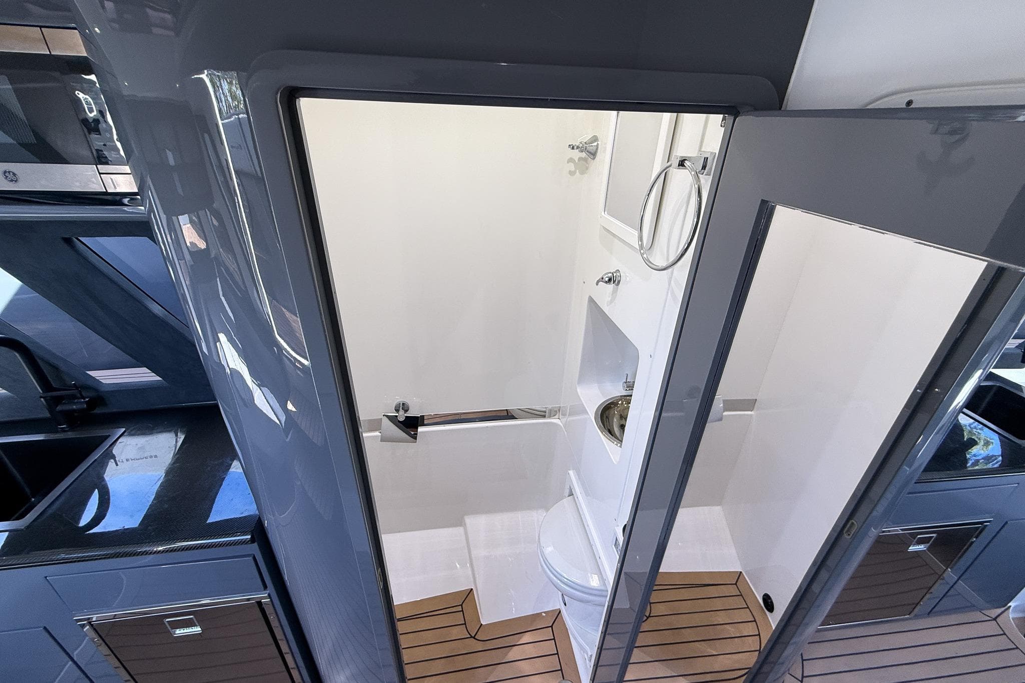 2023 Midnight Express 43 Solstice interior bathroom with modern fixtures and wooden flooring.