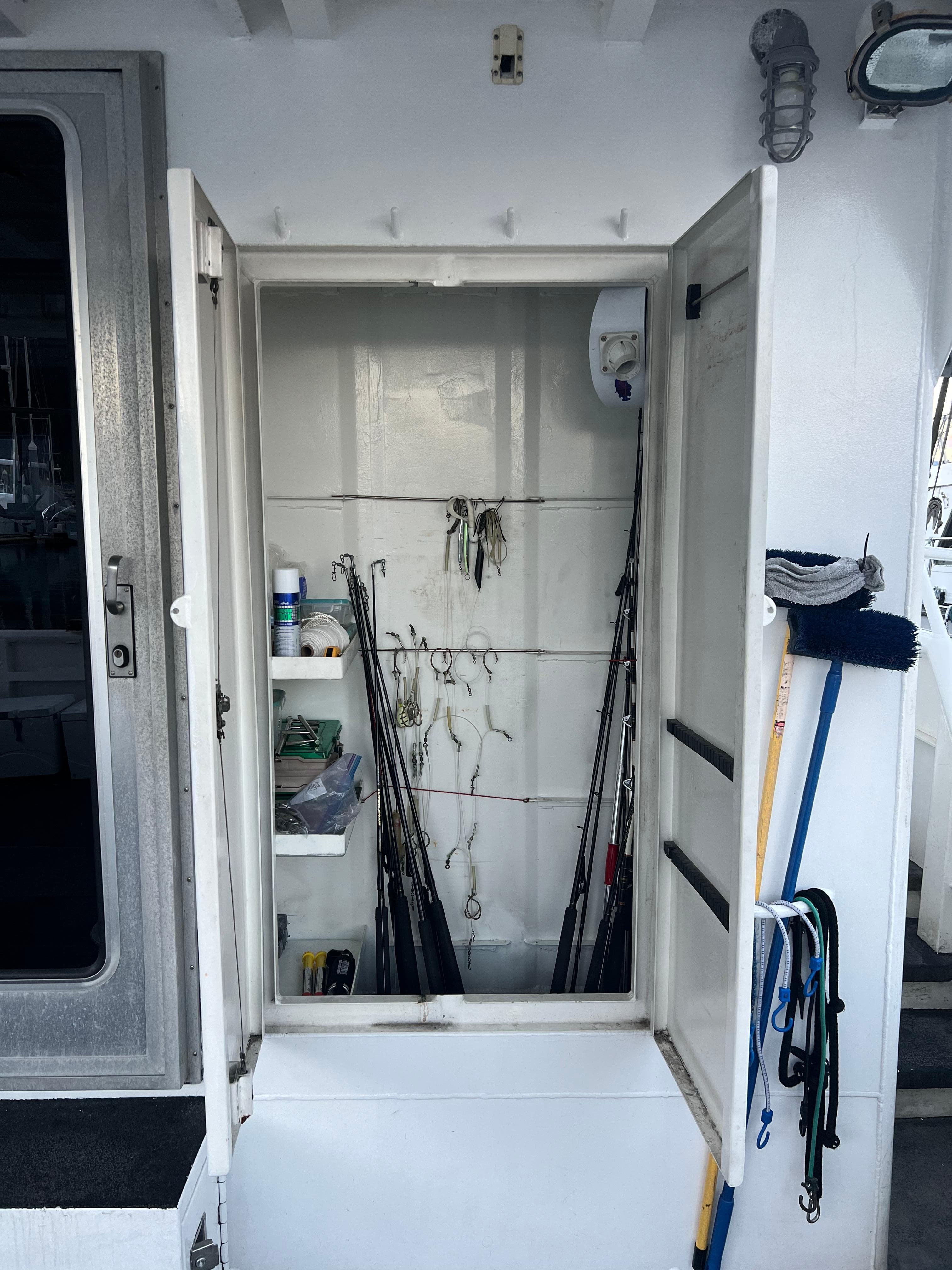 Storage compartment on a 2003 Peregrine 62 Custom boat with fishing gear and equipment.