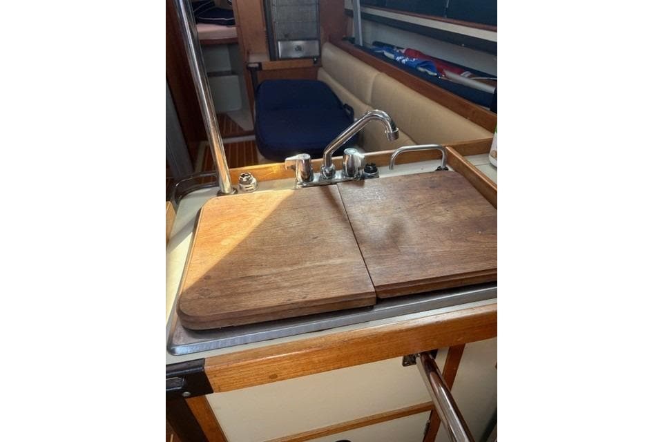 1982 C&C Yachts 37 interior galley with wooden countertop and sink.