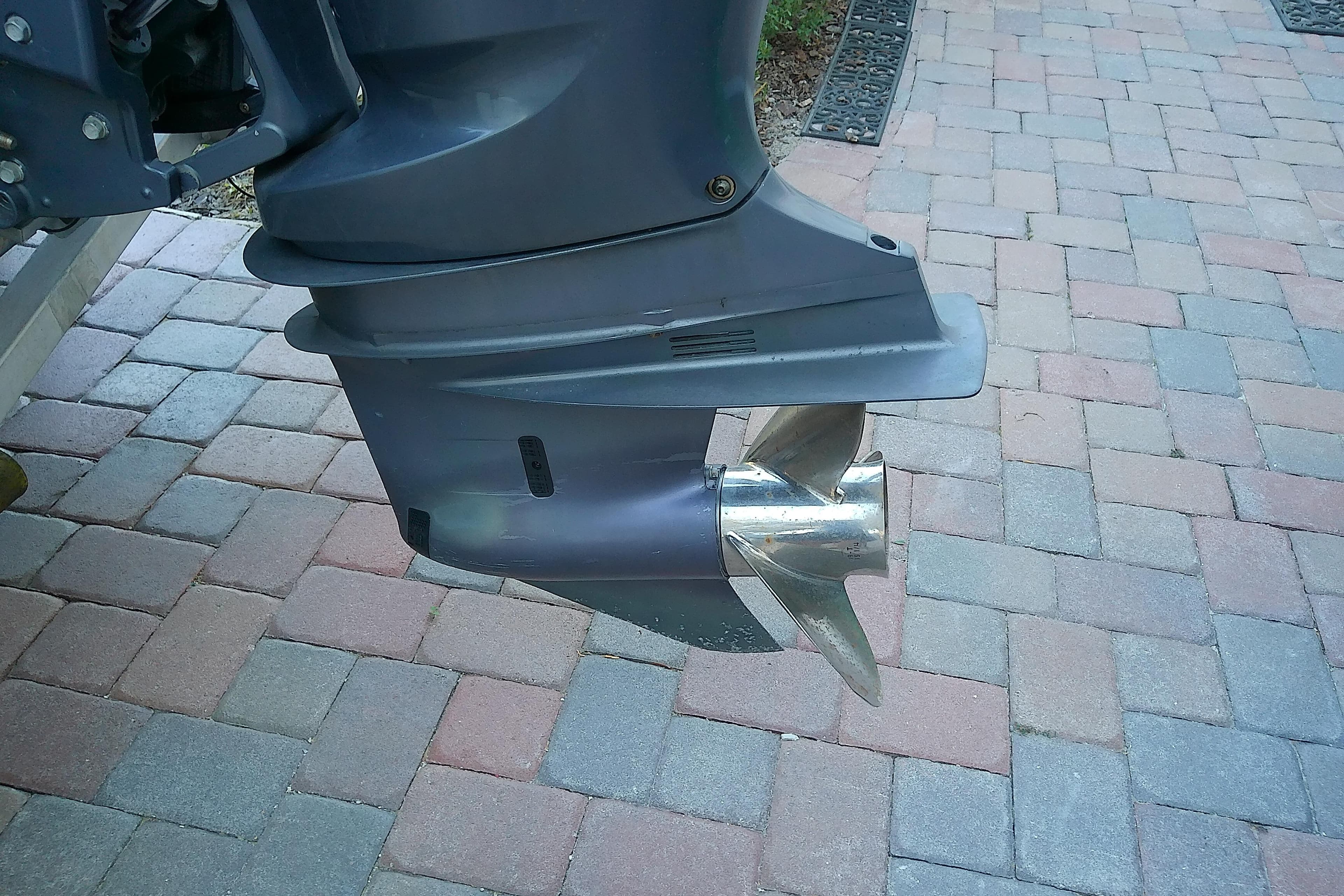 2018 Scout 251 XSS boat motor and propeller on brick pavement.