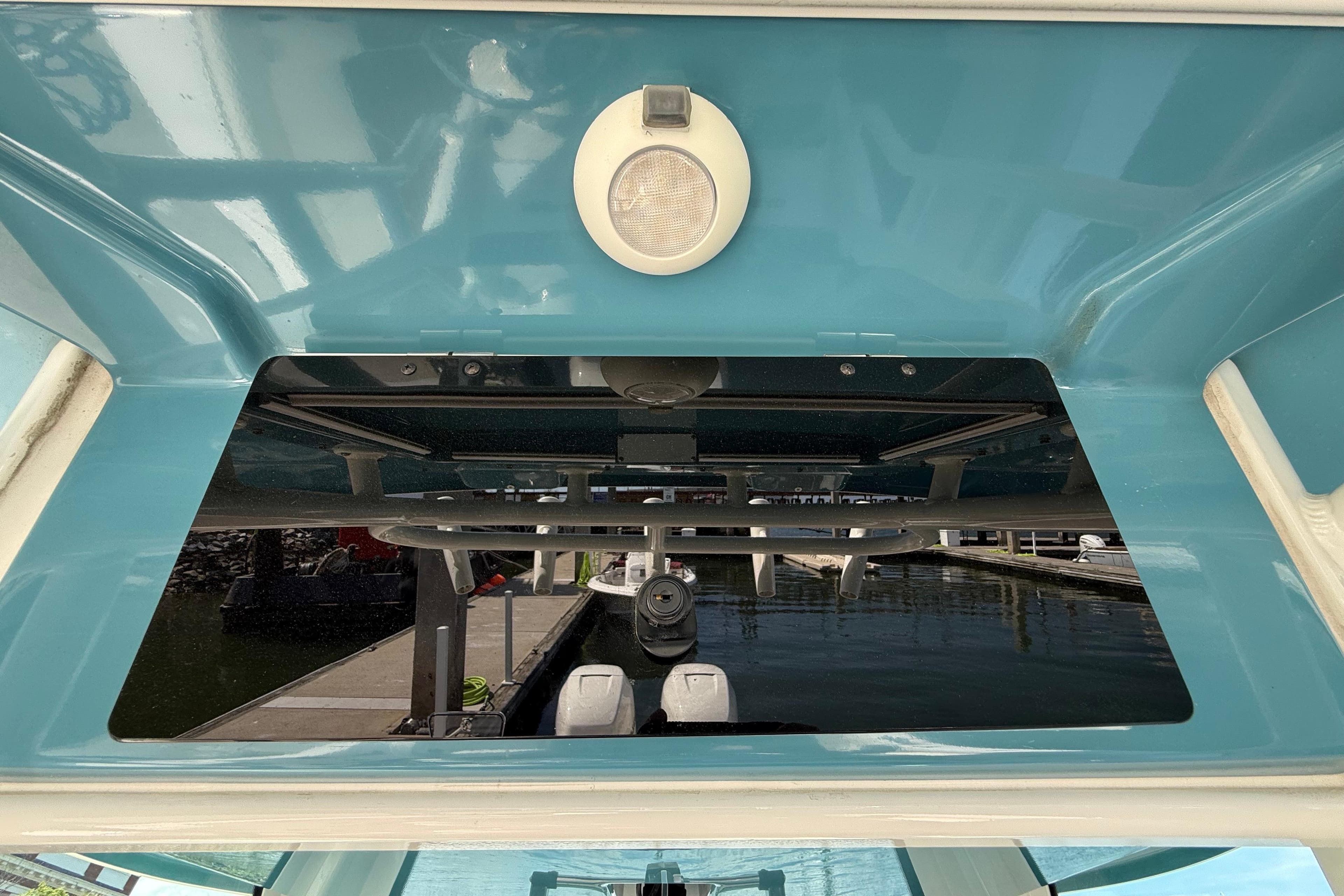 2023 Boston Whaler 280 Outrage boat interior with blue finish and overhead light.