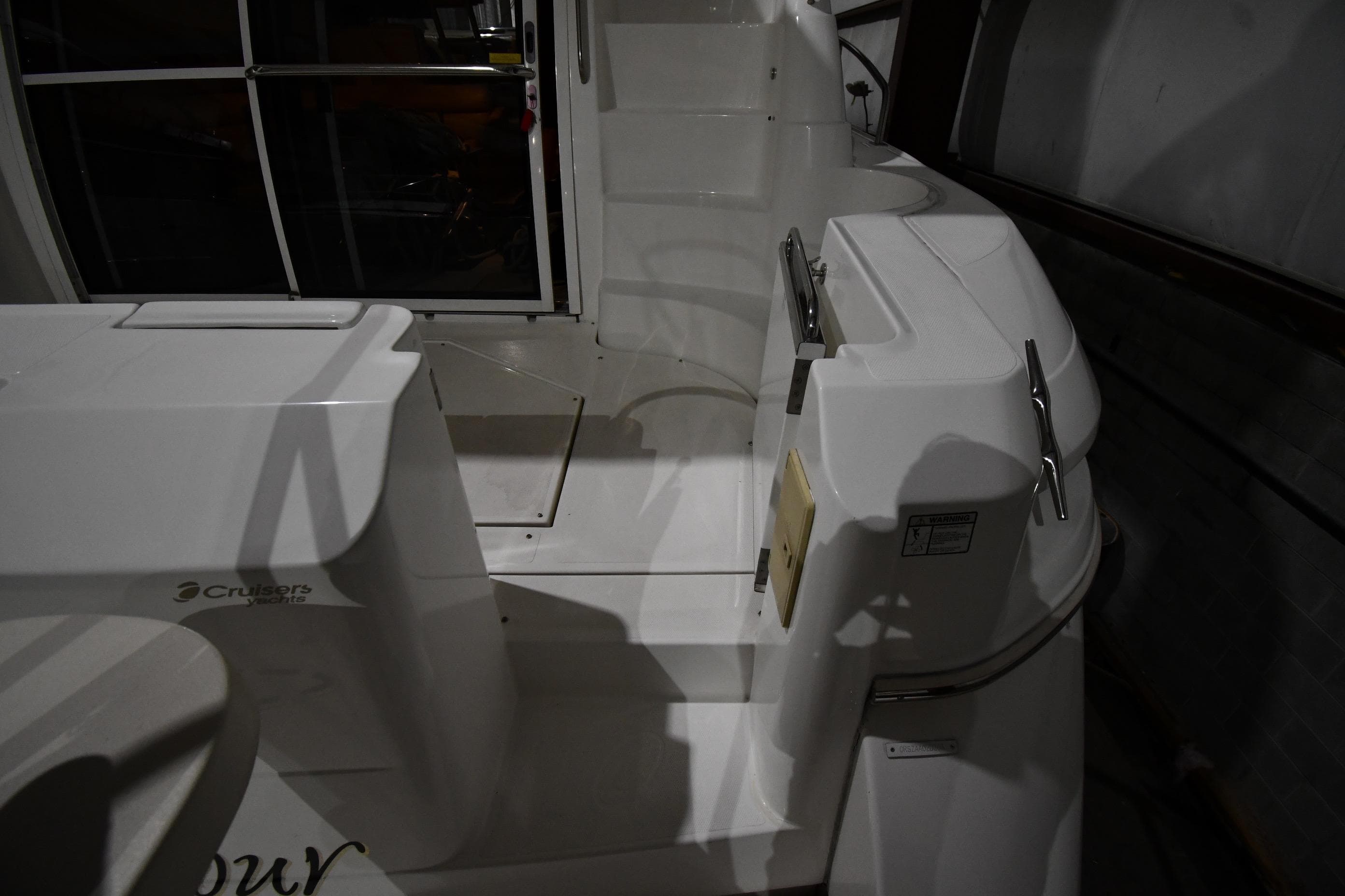 2003 Cruisers Yachts 5000 Sedan Sport, white deck area with steps and railing.