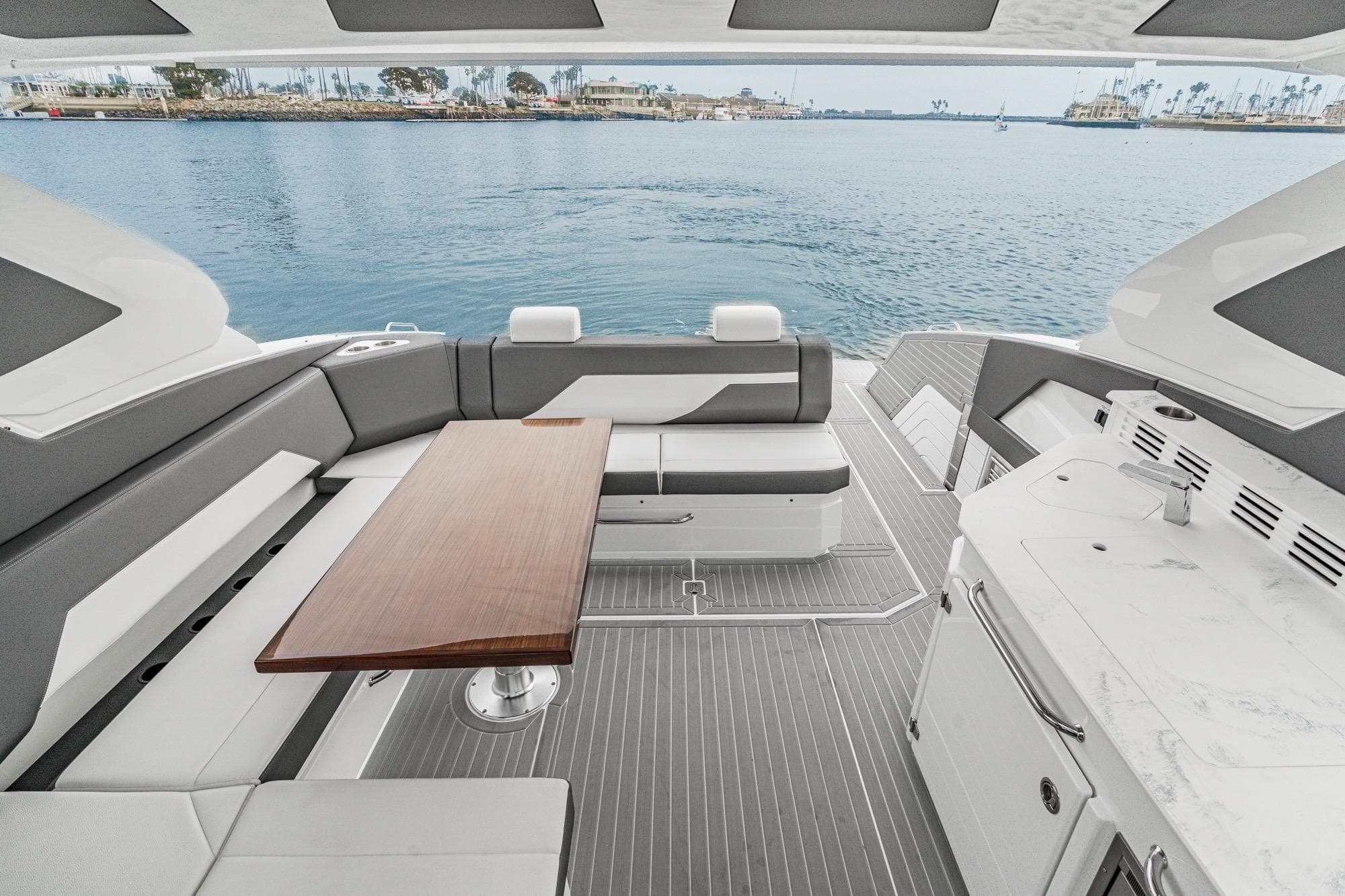Luxurious 2022 Cruisers 42 GLS yacht interior with elegant seating and wooden table.