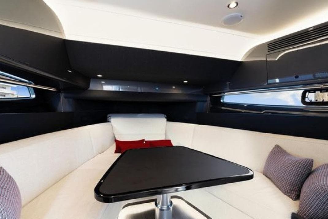 Luxurious interior of 2023 Azimut Verve 42 yacht with elegant seating and table.
