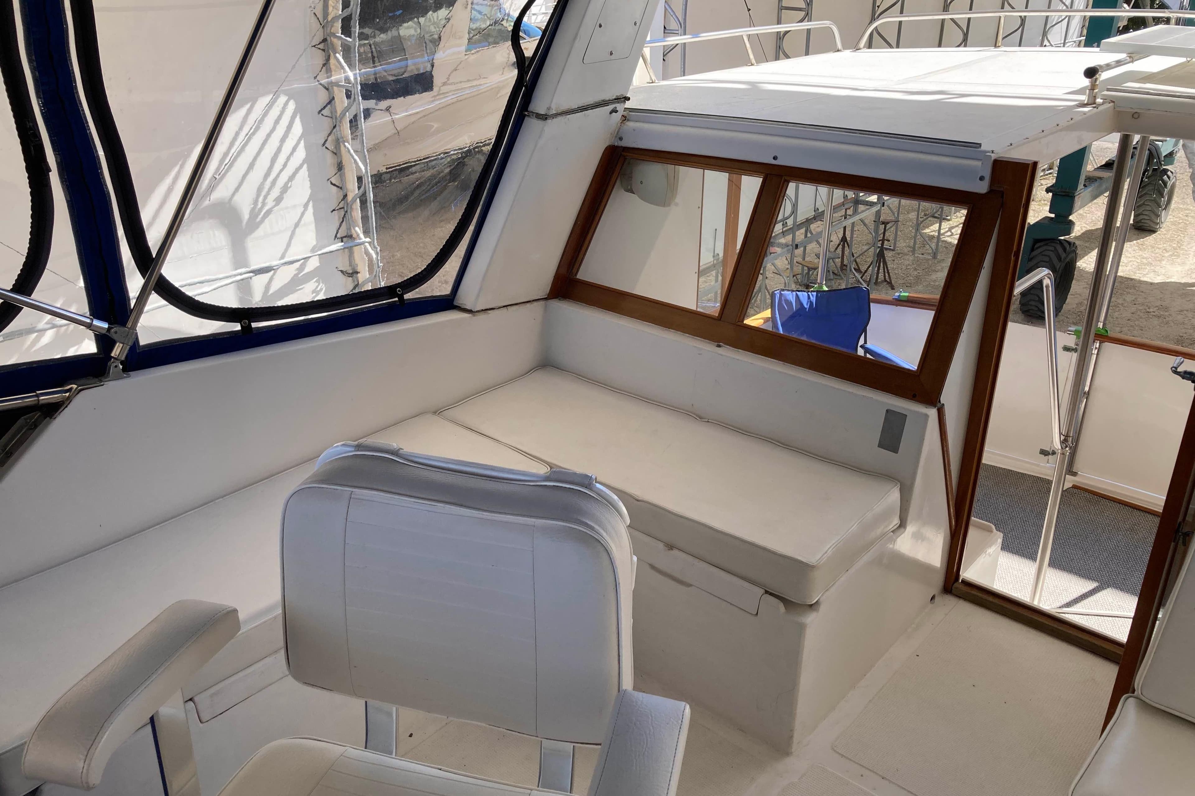 1986 Heritage East Sundeck interior with white seating and wooden accents.