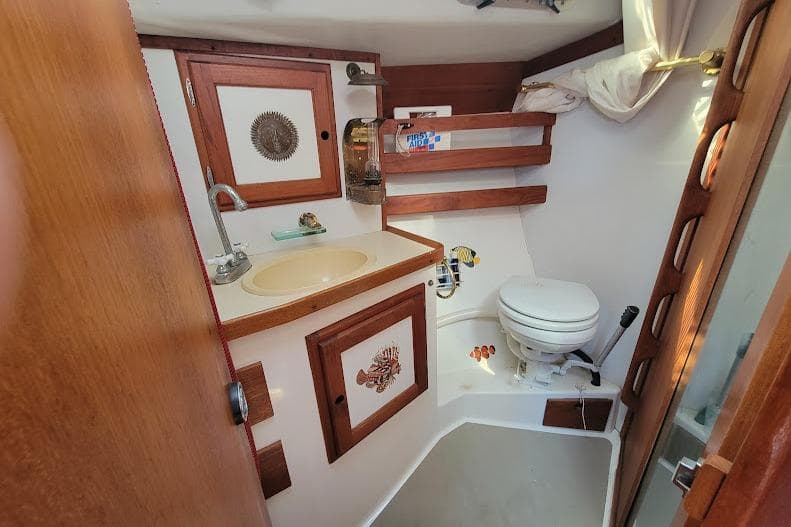 1988 Freedom Yachts FREEDOM 36 yacht bathroom with wooden accents and compact design.