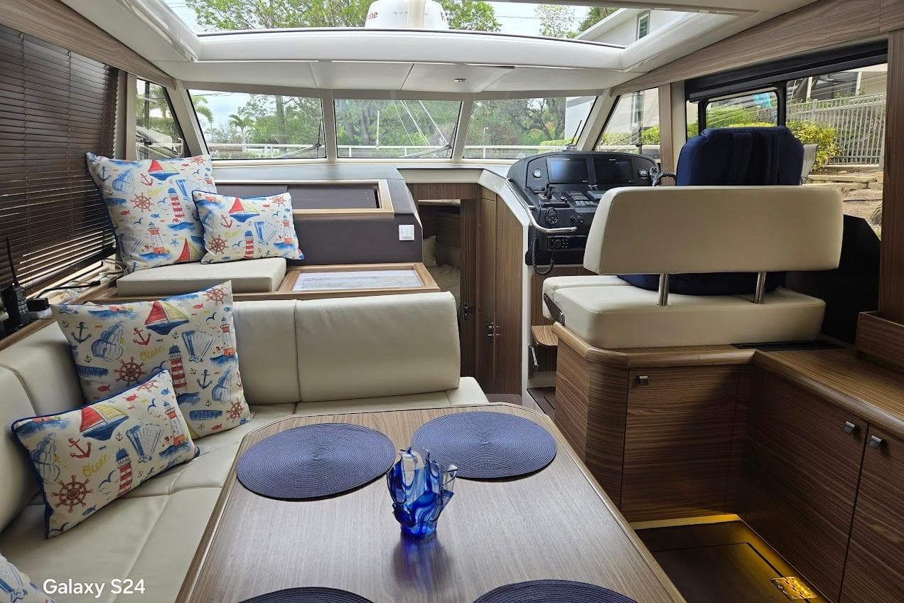 Luxurious interior of 2019 Greenline 40 yacht with nautical-themed decor and modern helm.