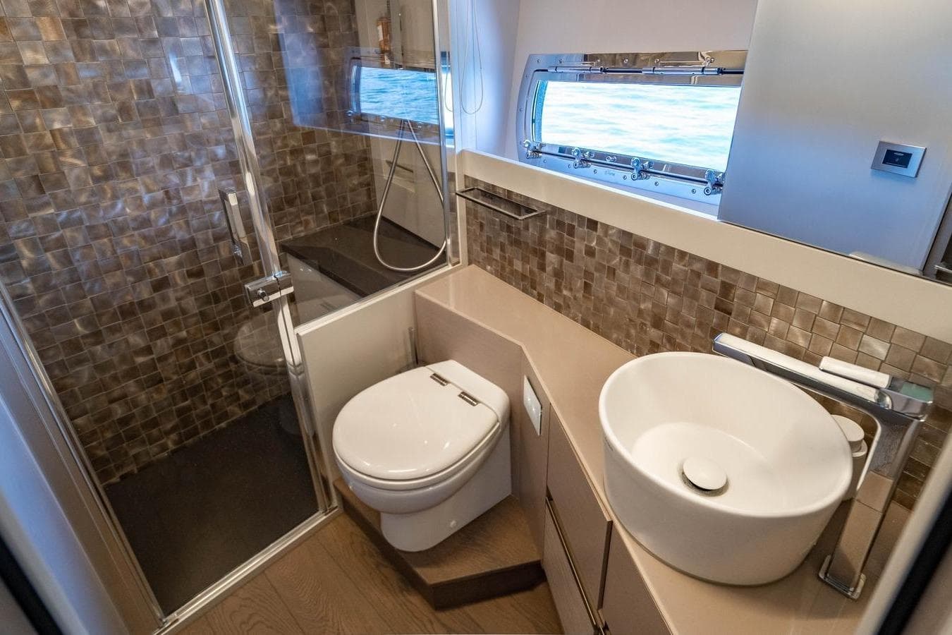 Luxurious bathroom in 2023 Pershing 7X yacht with modern fixtures and ocean view.
