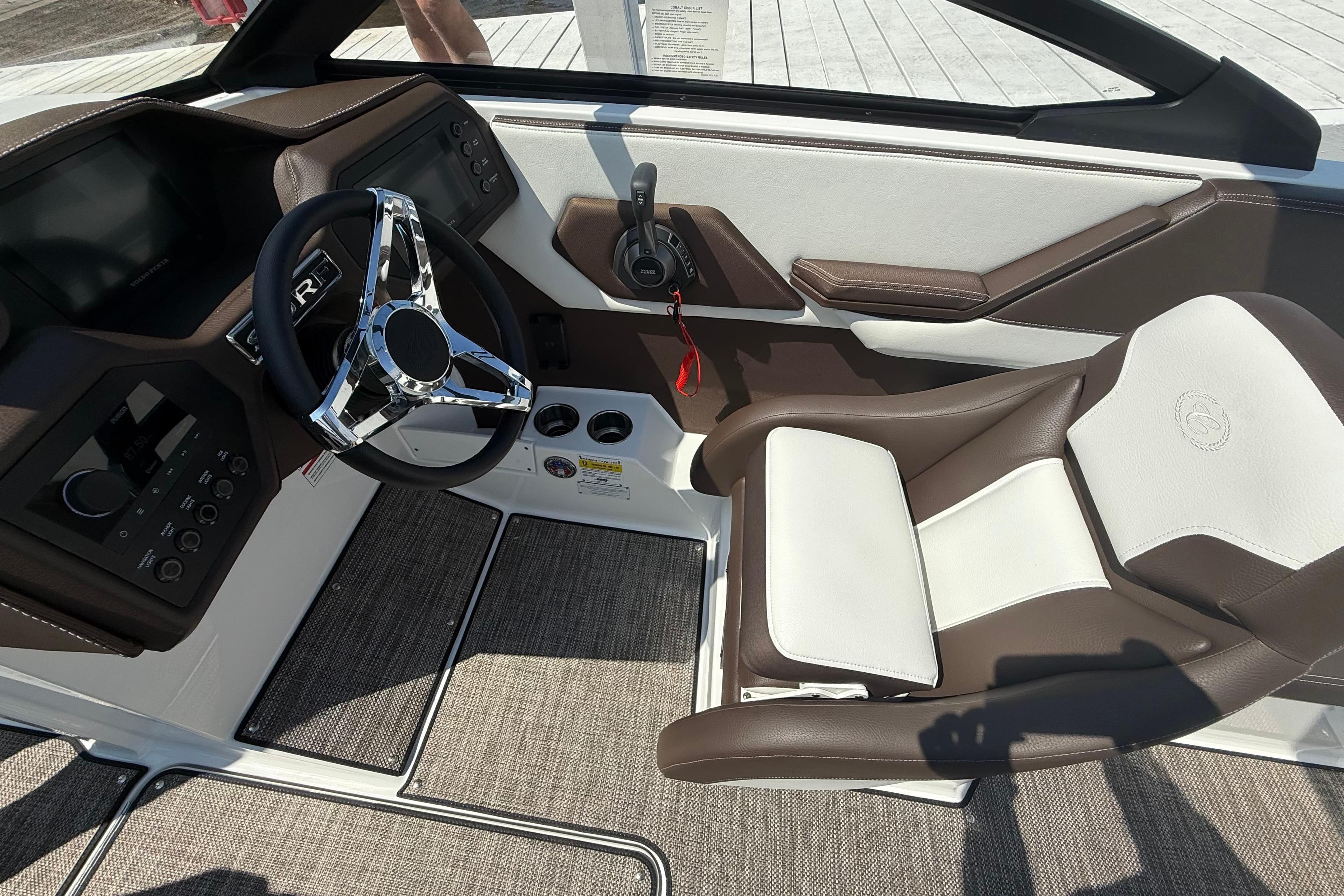 2025 Cobalt CS23 Surf boat interior with modern steering wheel and comfortable seating.