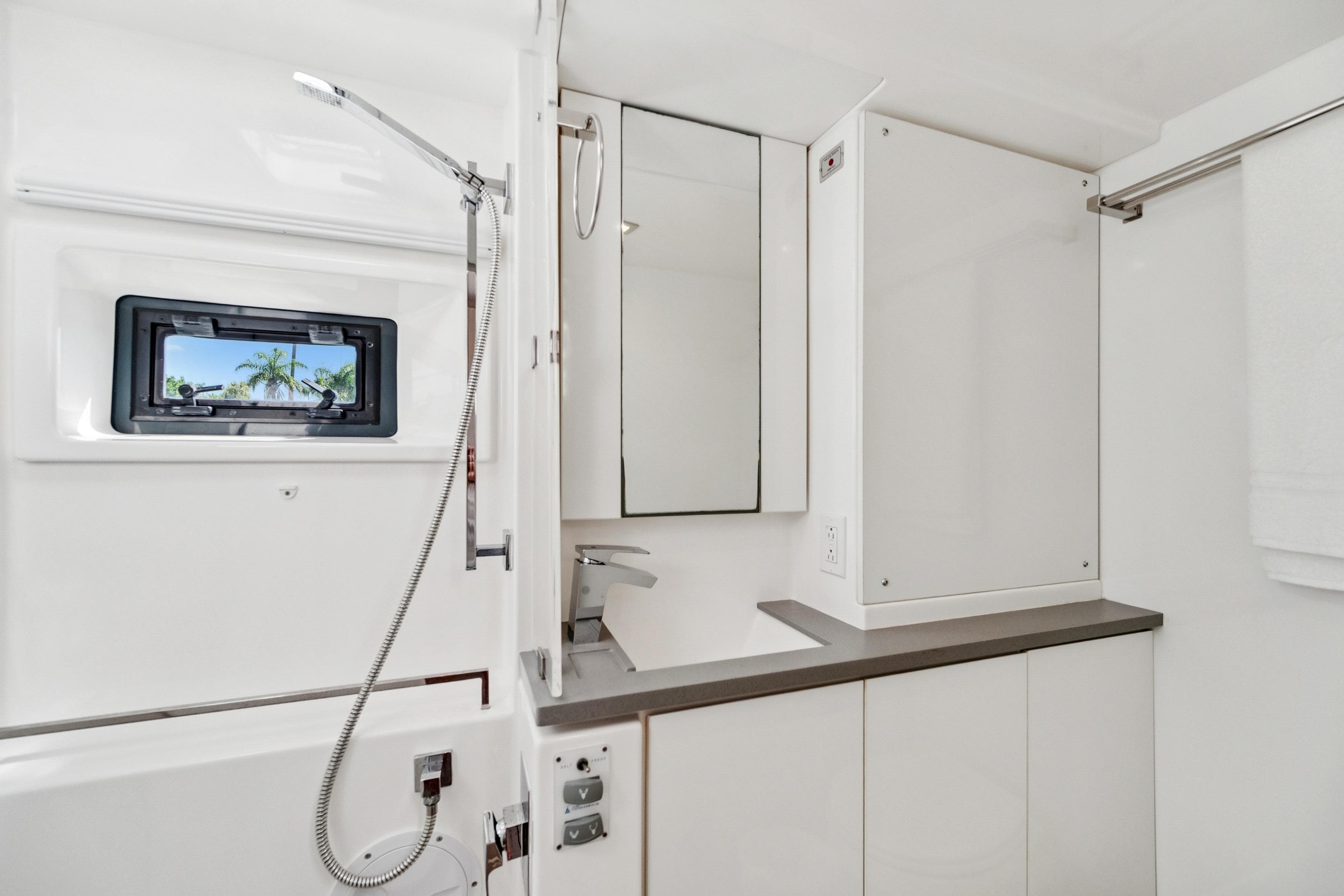 Modern bathroom interior of 2021 Leopard 45 yacht with sleek fixtures and window view.