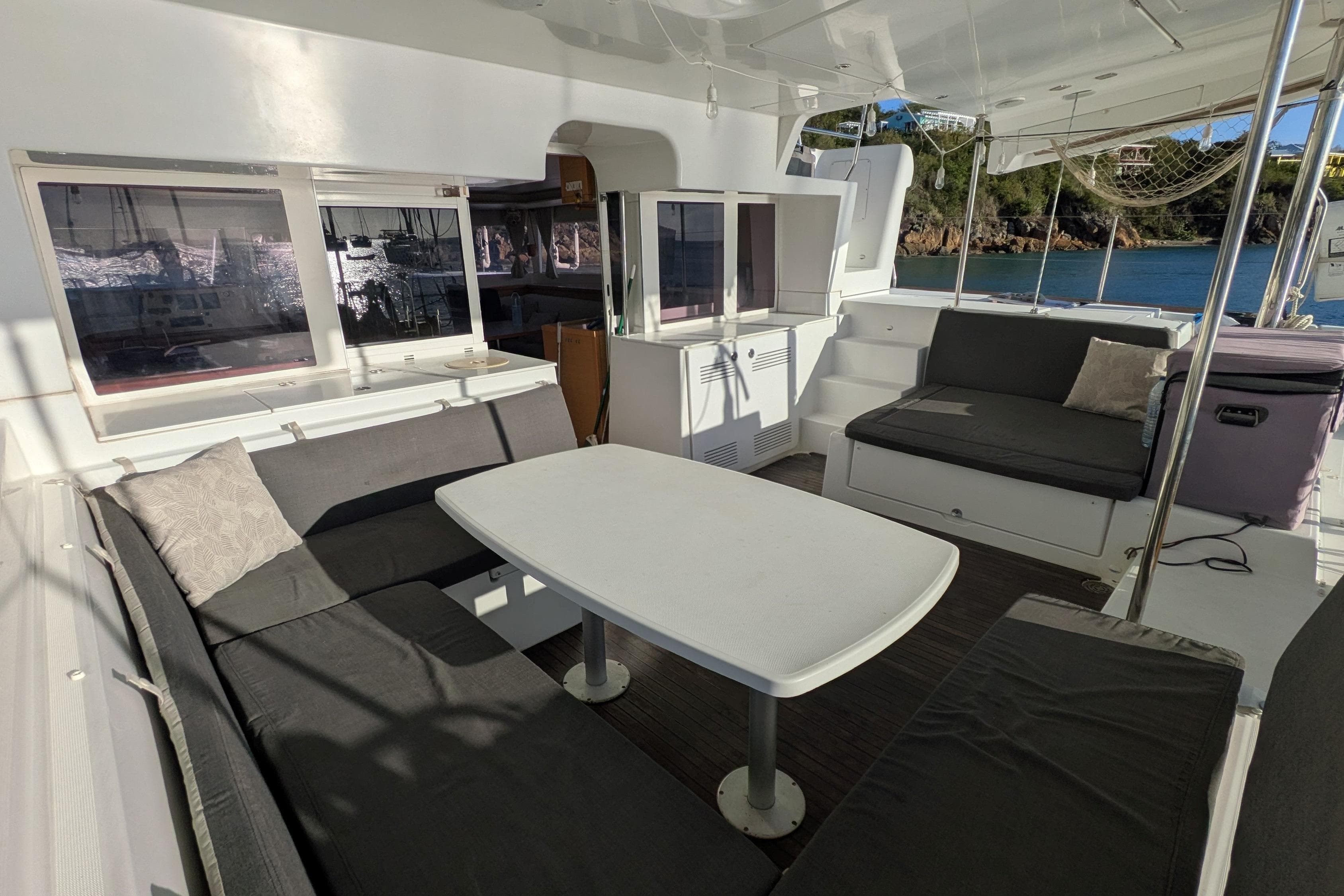 Spacious Lagoon 450 catamaran cockpit with comfortable seating and table, 2012 model.