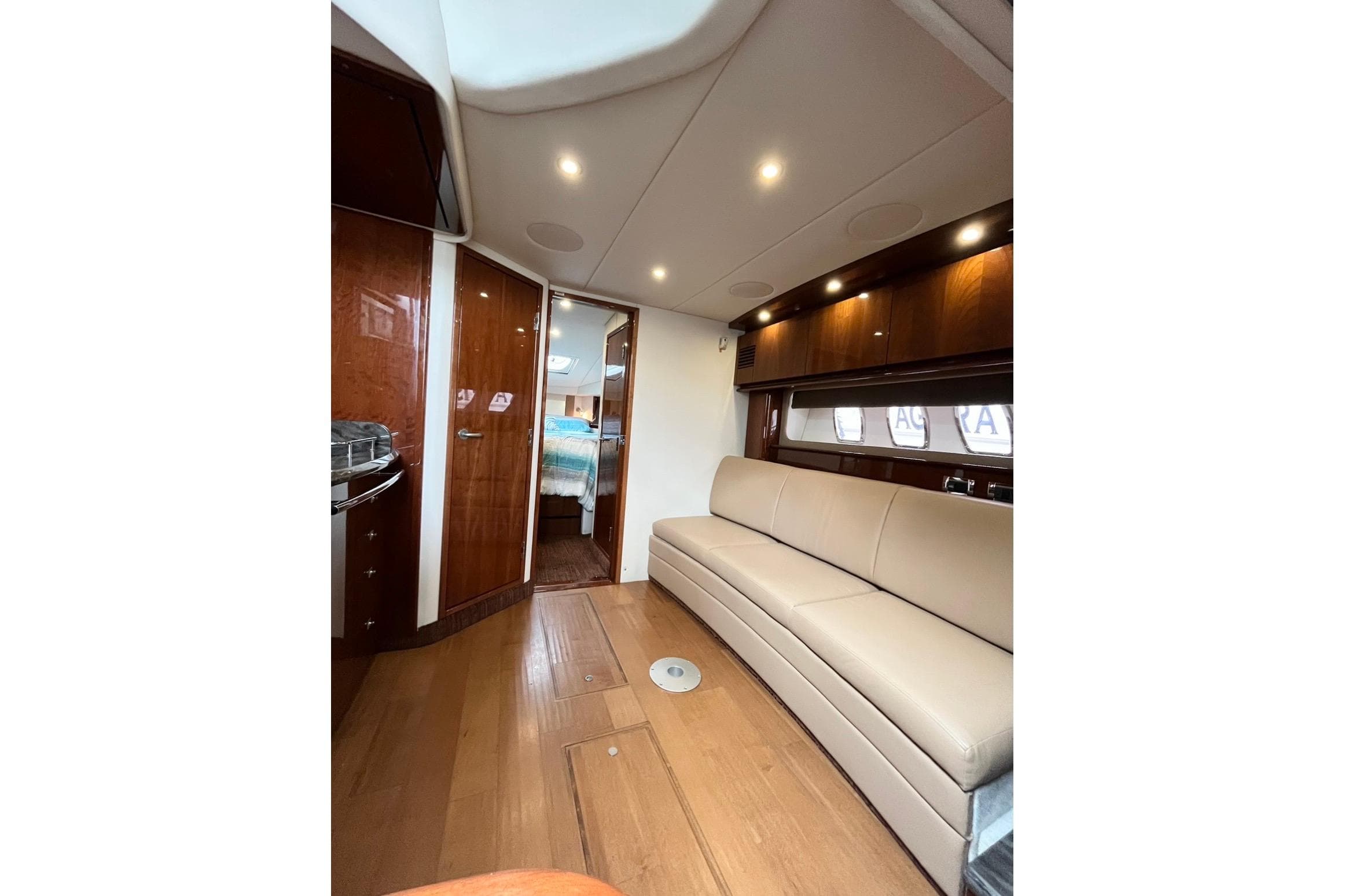 Luxurious interior of 2012 Sea Ray 390 Sundancer yacht with elegant seating and wood finishes.