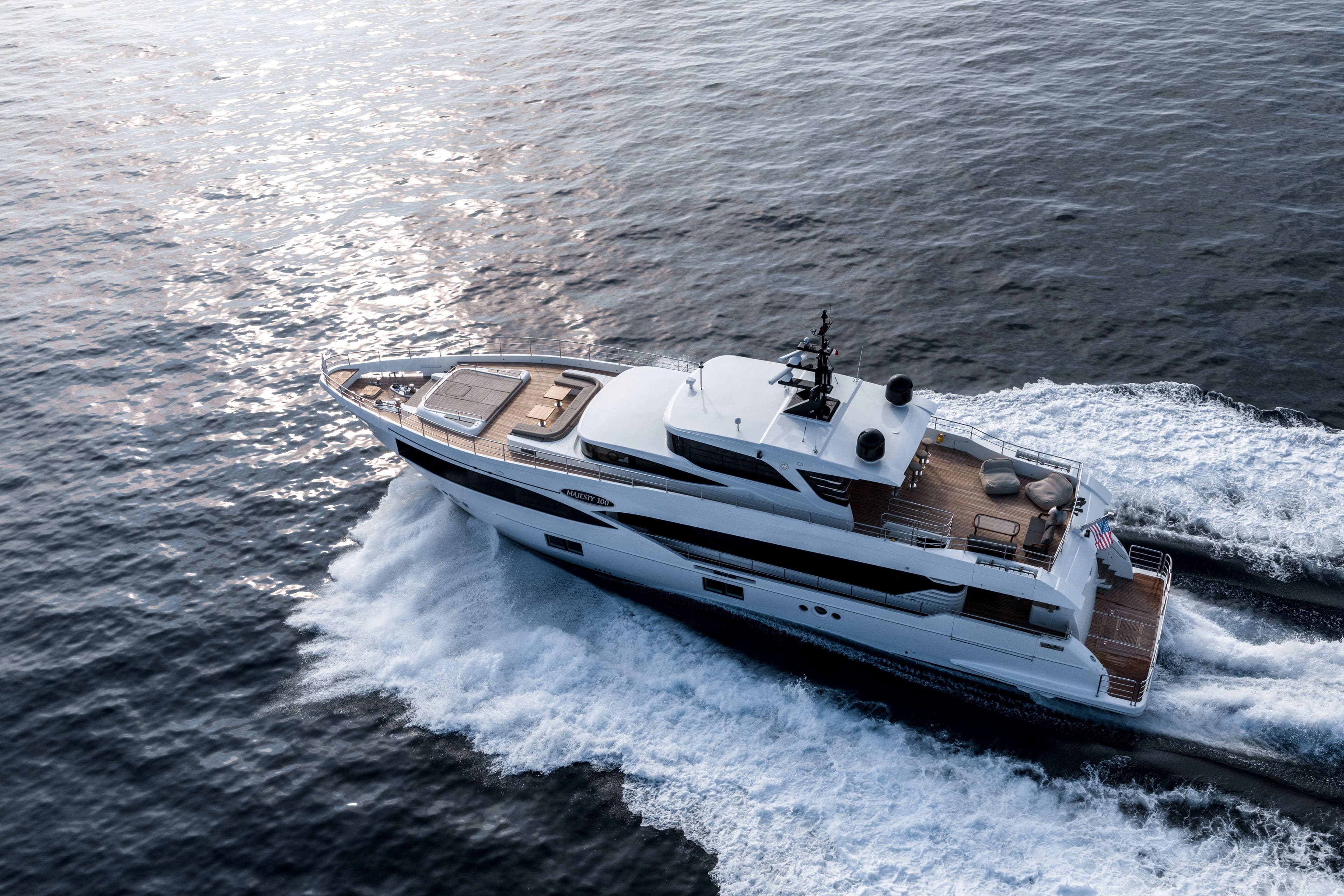 Majesty 100 yacht cruising on open water, 2025 model, aerial view.