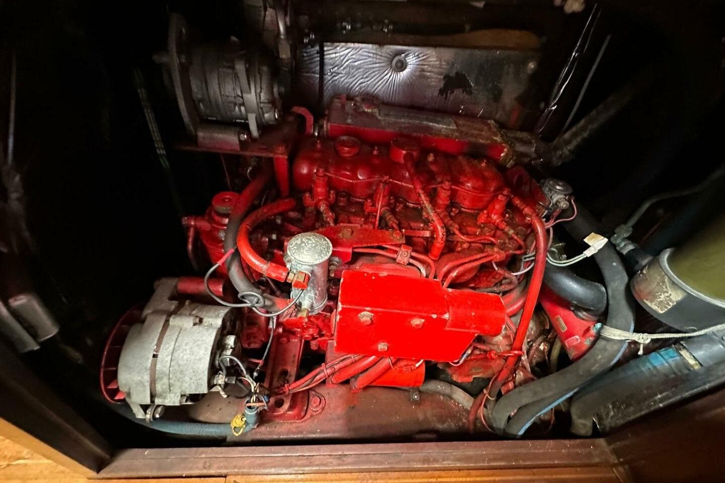 Red engine of a 1988 Cambria 46, featuring intricate wiring and components.
