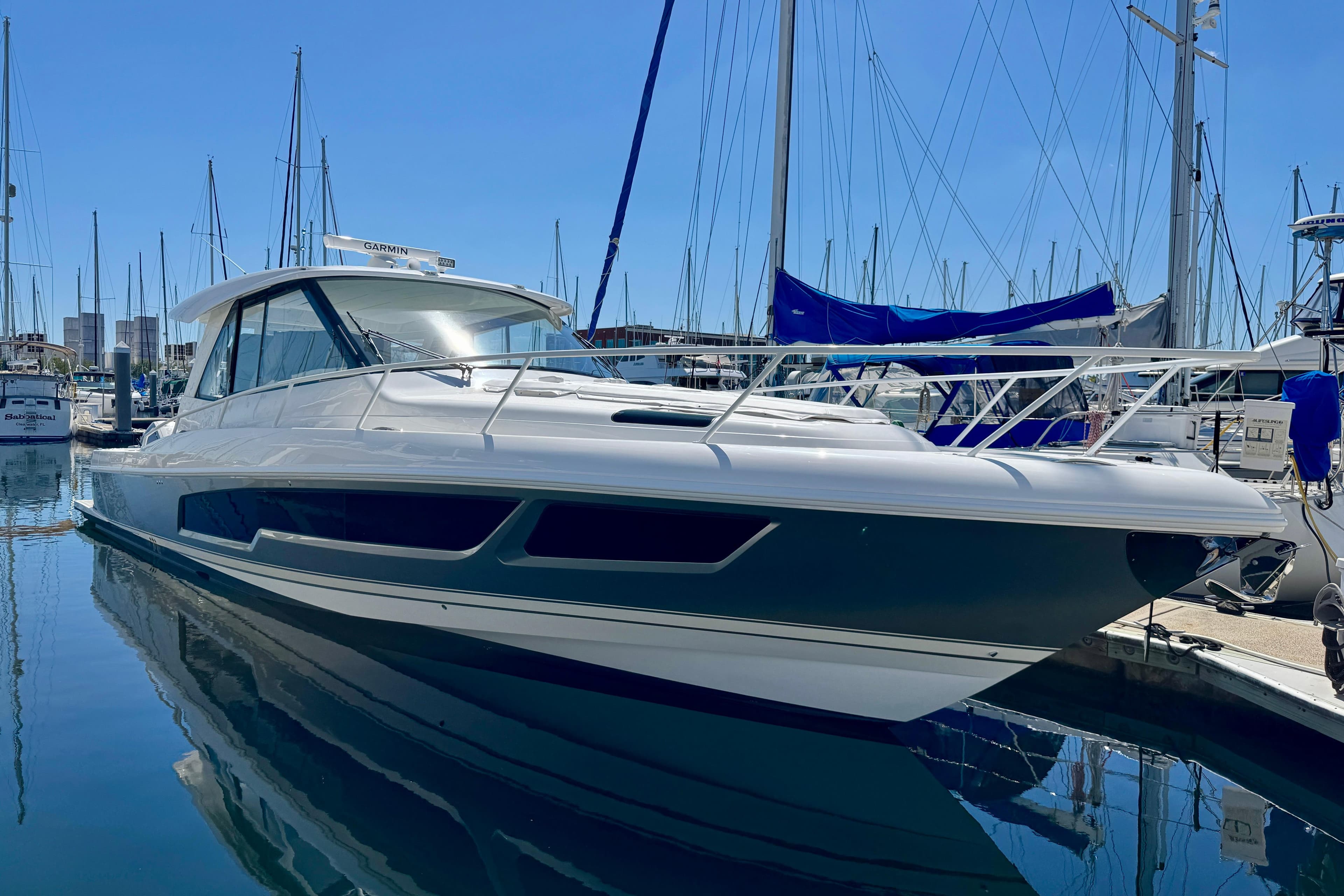 2025 Intrepid 50 Evolution yacht docked in a marina under clear blue skies.