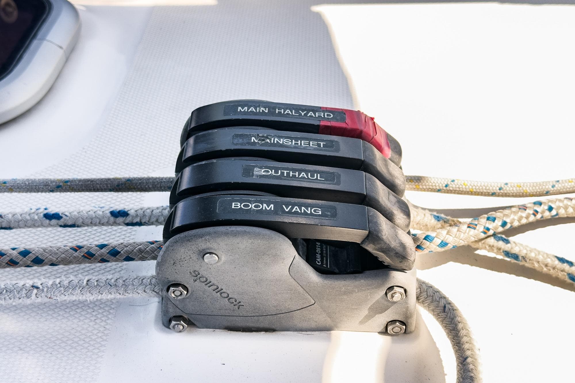 Sailboat control lines labeled for main halyard, mainsheet, outhaul, and boom vang on a 2007 Hunter 38.