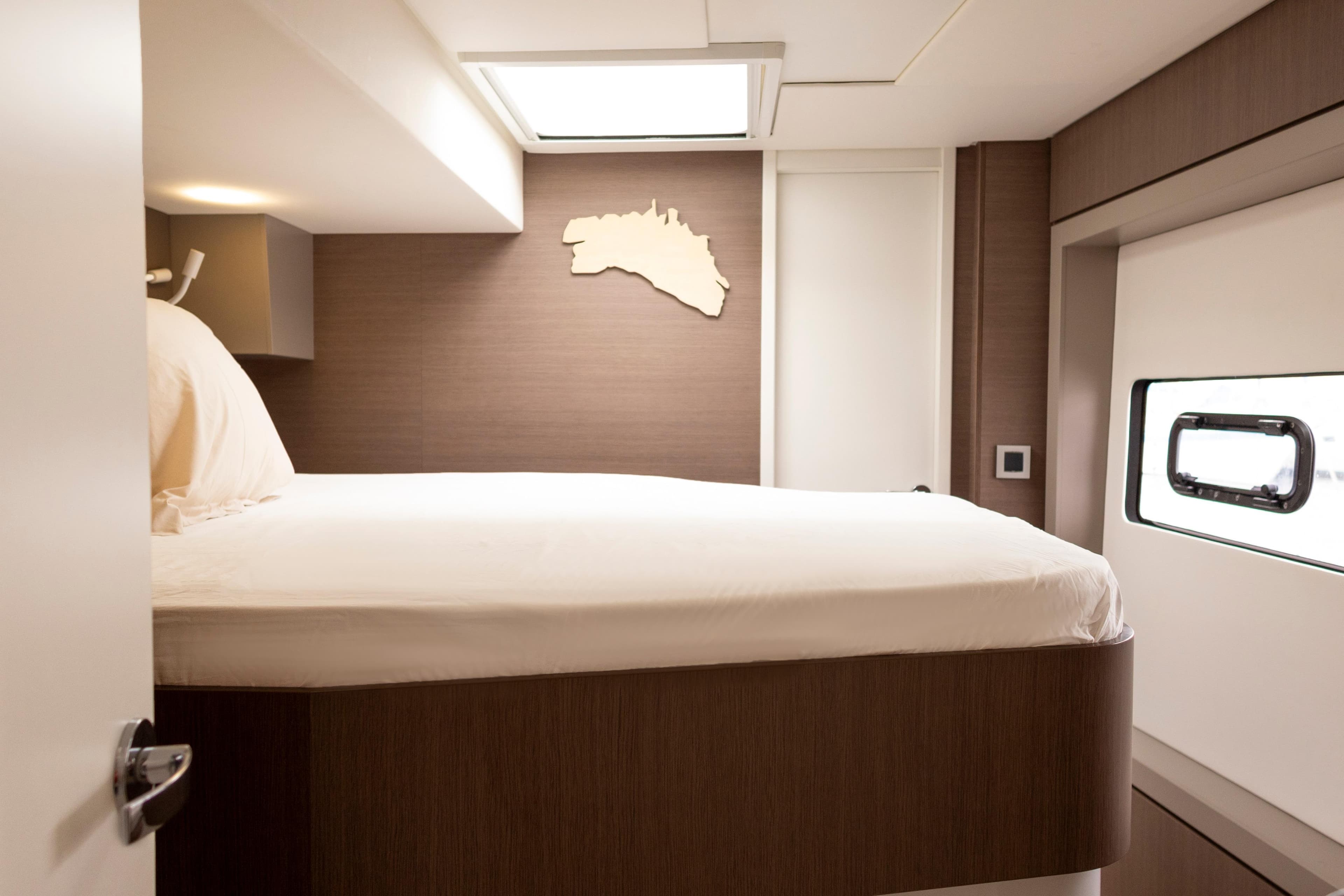 Luxurious cabin interior of 2020 Bali 4.8 yacht with modern design and comfortable bedding.