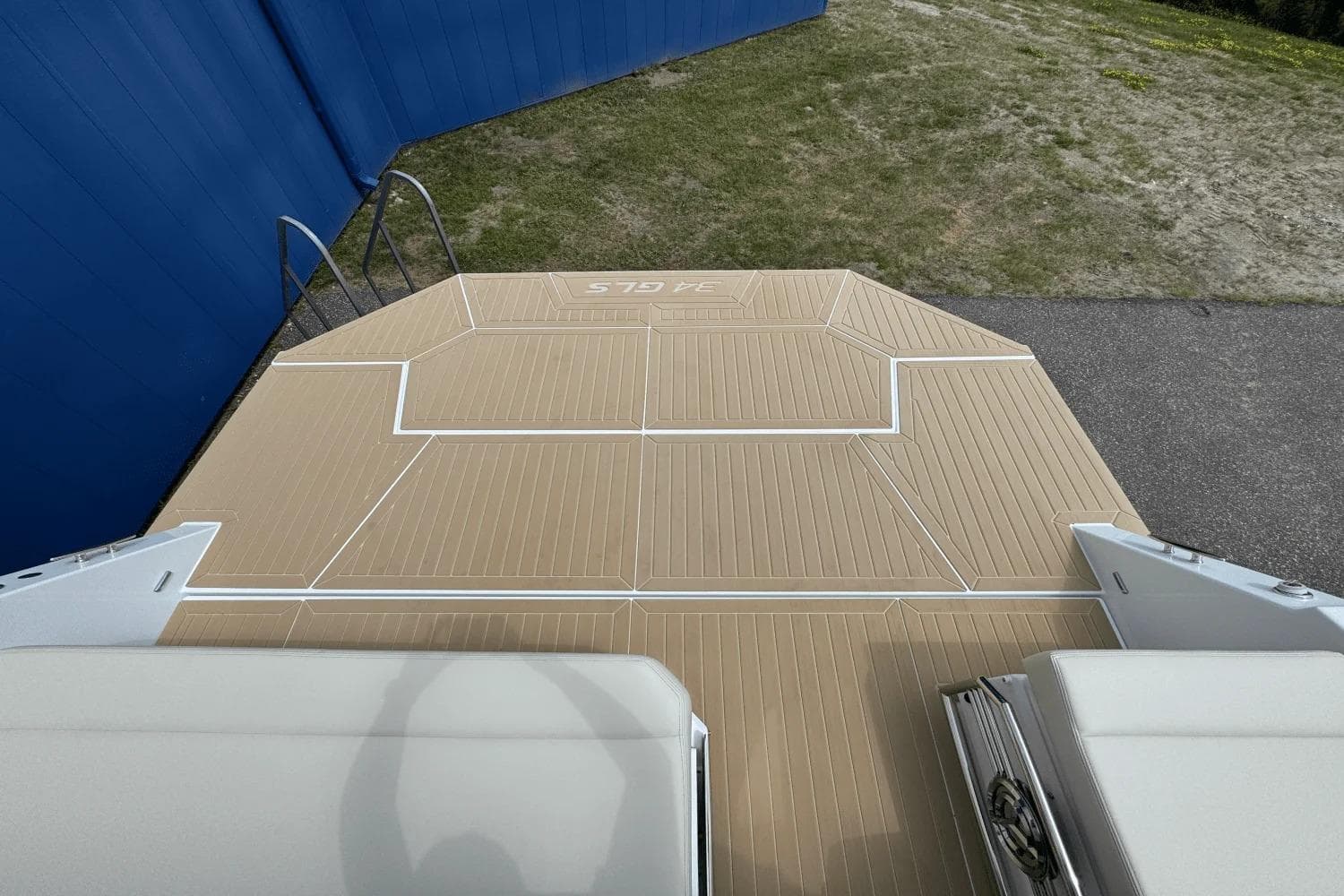 2026 Cruisers Yachts 34 GLS I/O swim platform with ladder, beige decking.