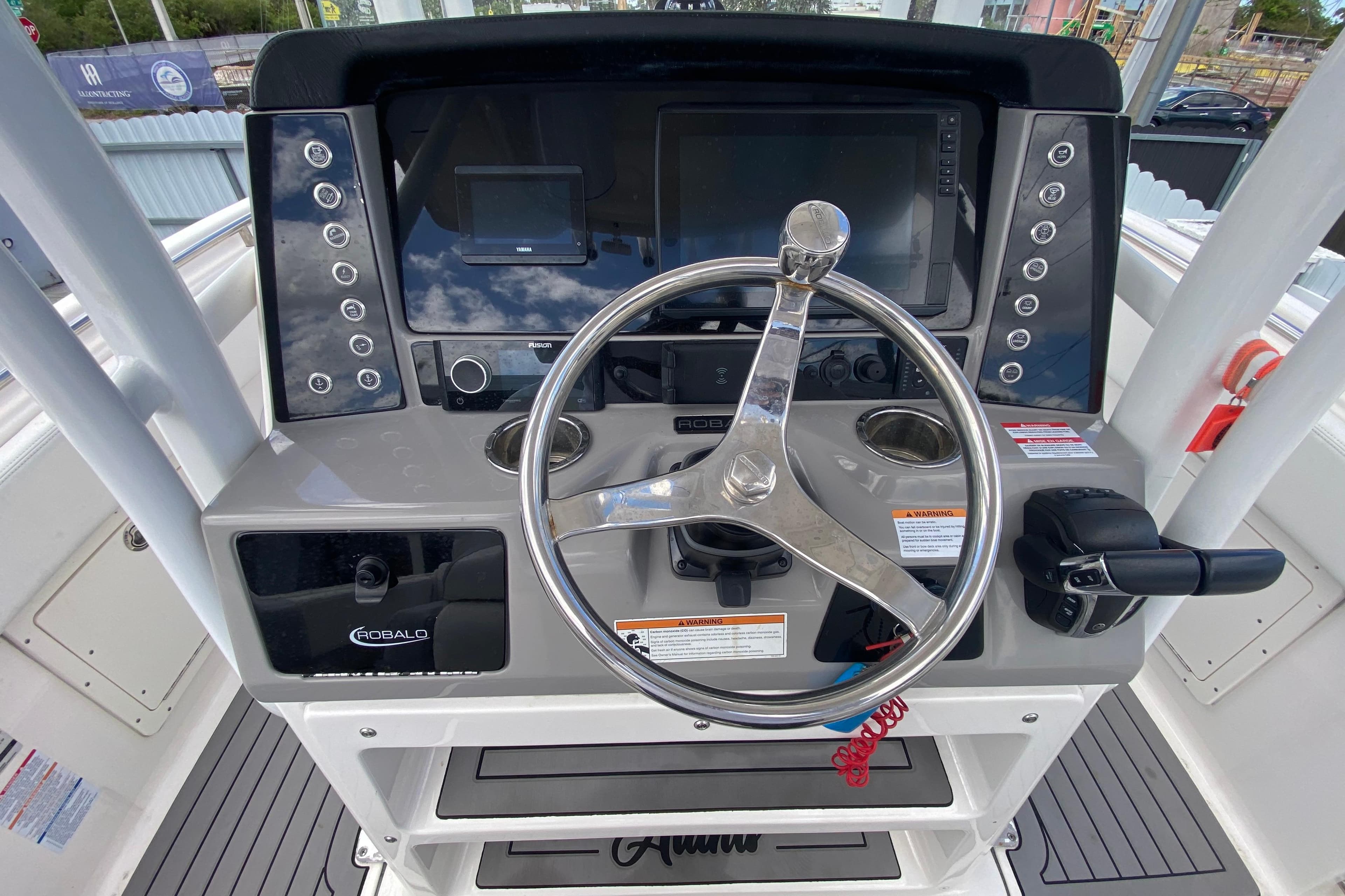 2022 Robalo R242 Center Console boat dashboard with steering wheel and controls.