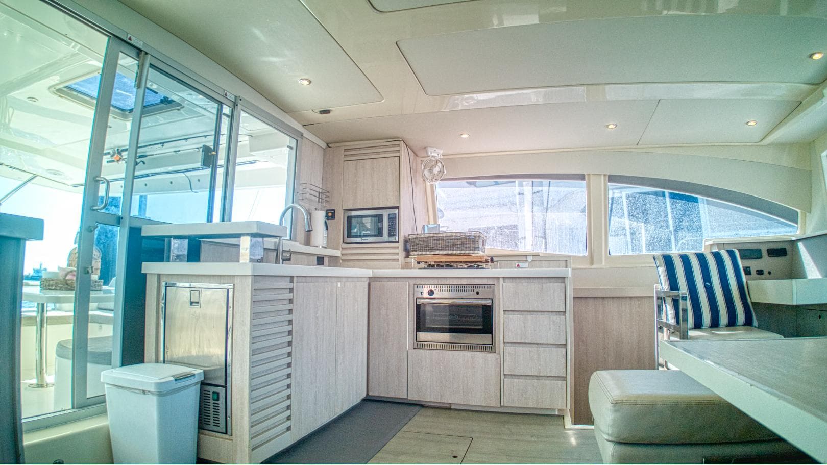 Luxurious interior of 2015 Leopard 48 yacht with modern kitchen and seating area.