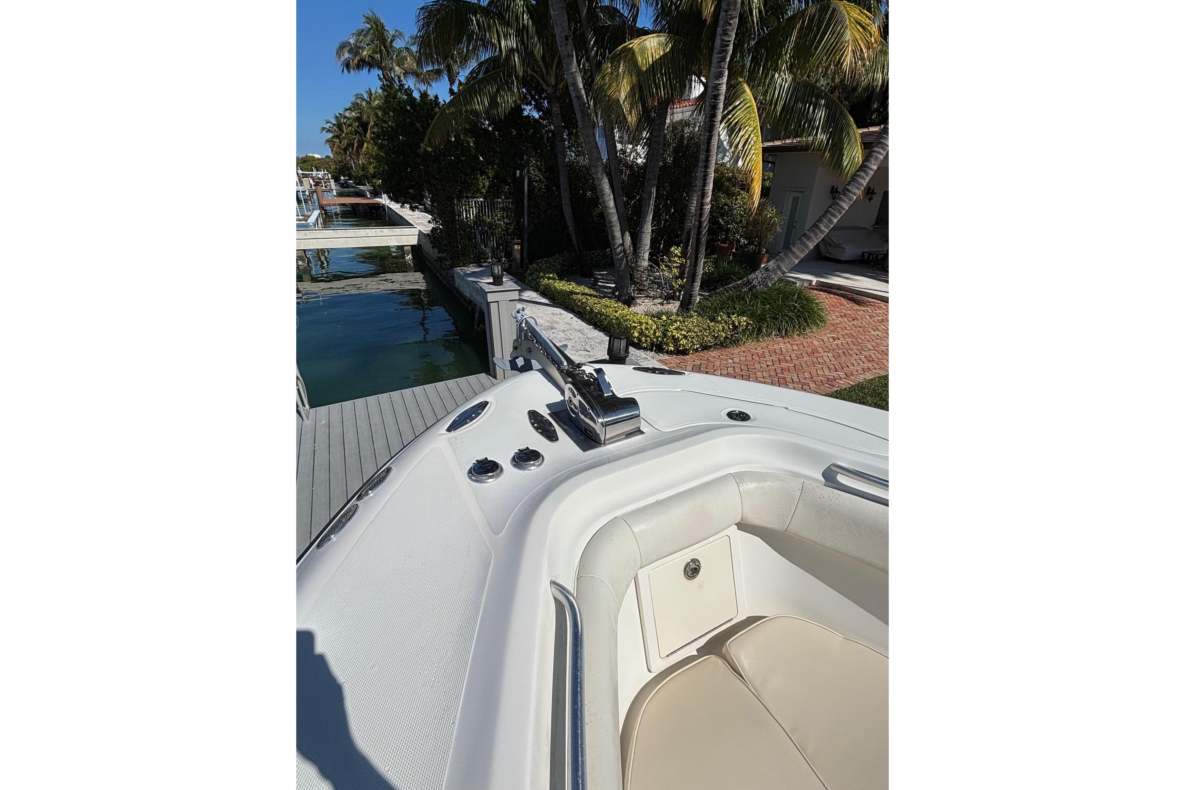 2006 Hydra-Sports Vector 3300 CC boat docked near palm trees and waterfront.