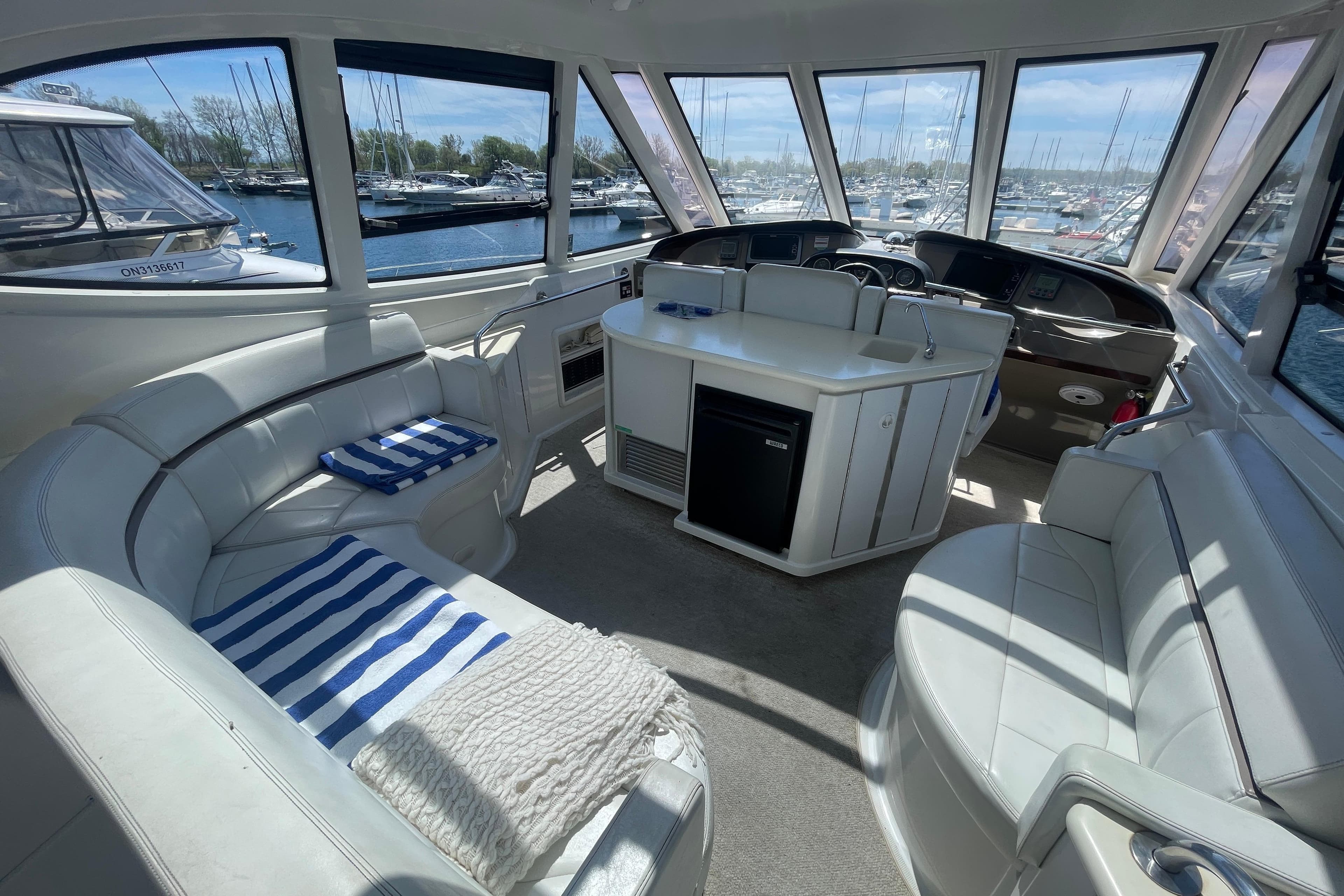 Interior of 2000 Carver 506 Motor Yacht with plush seating and panoramic windows.