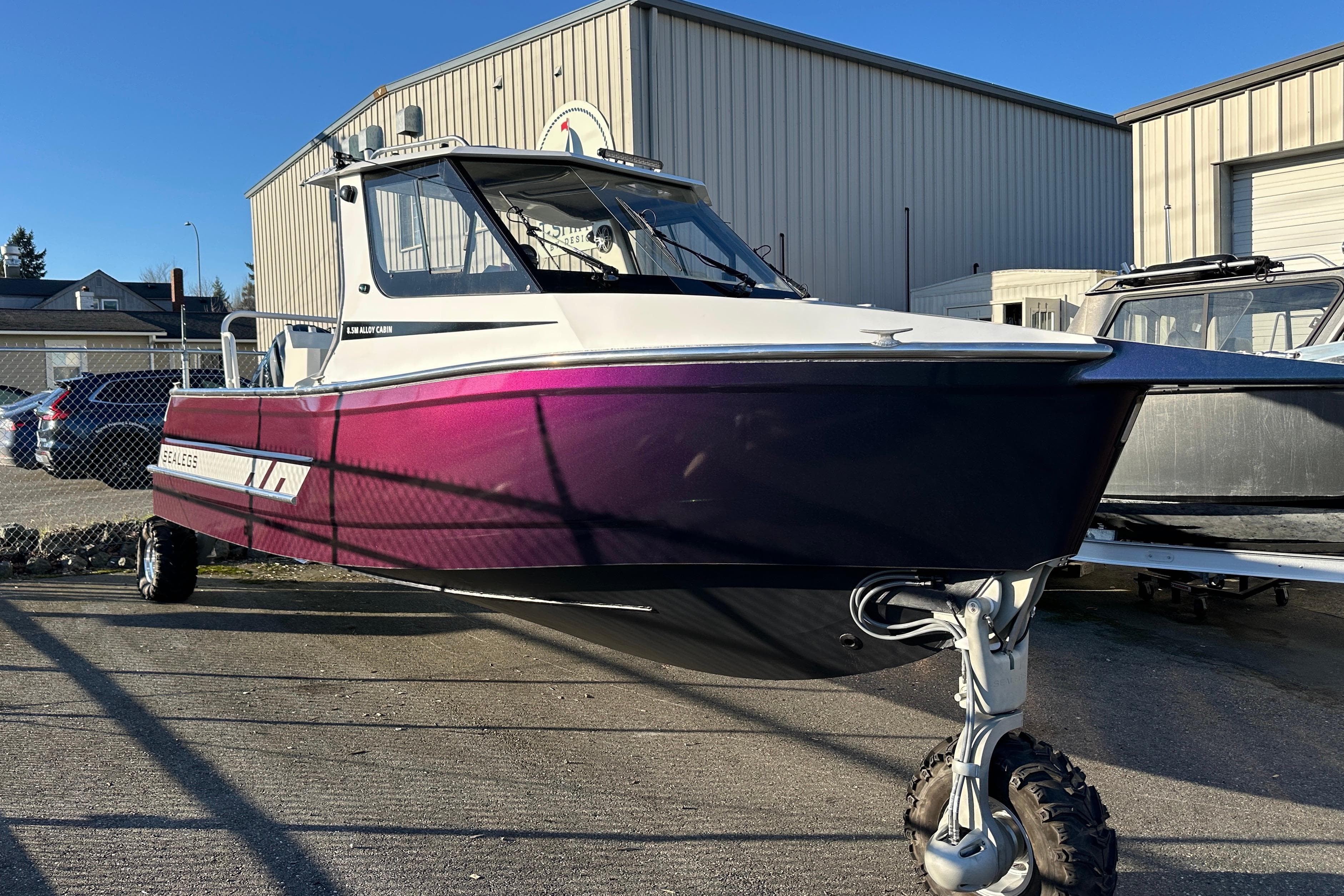 2026 Sealegs 8.5m Cabin boat with amphibious wheels, parked outdoors.
