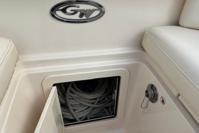 2024 Grady-White Freedom 307 boat storage compartment with coiled rope and GW logo.