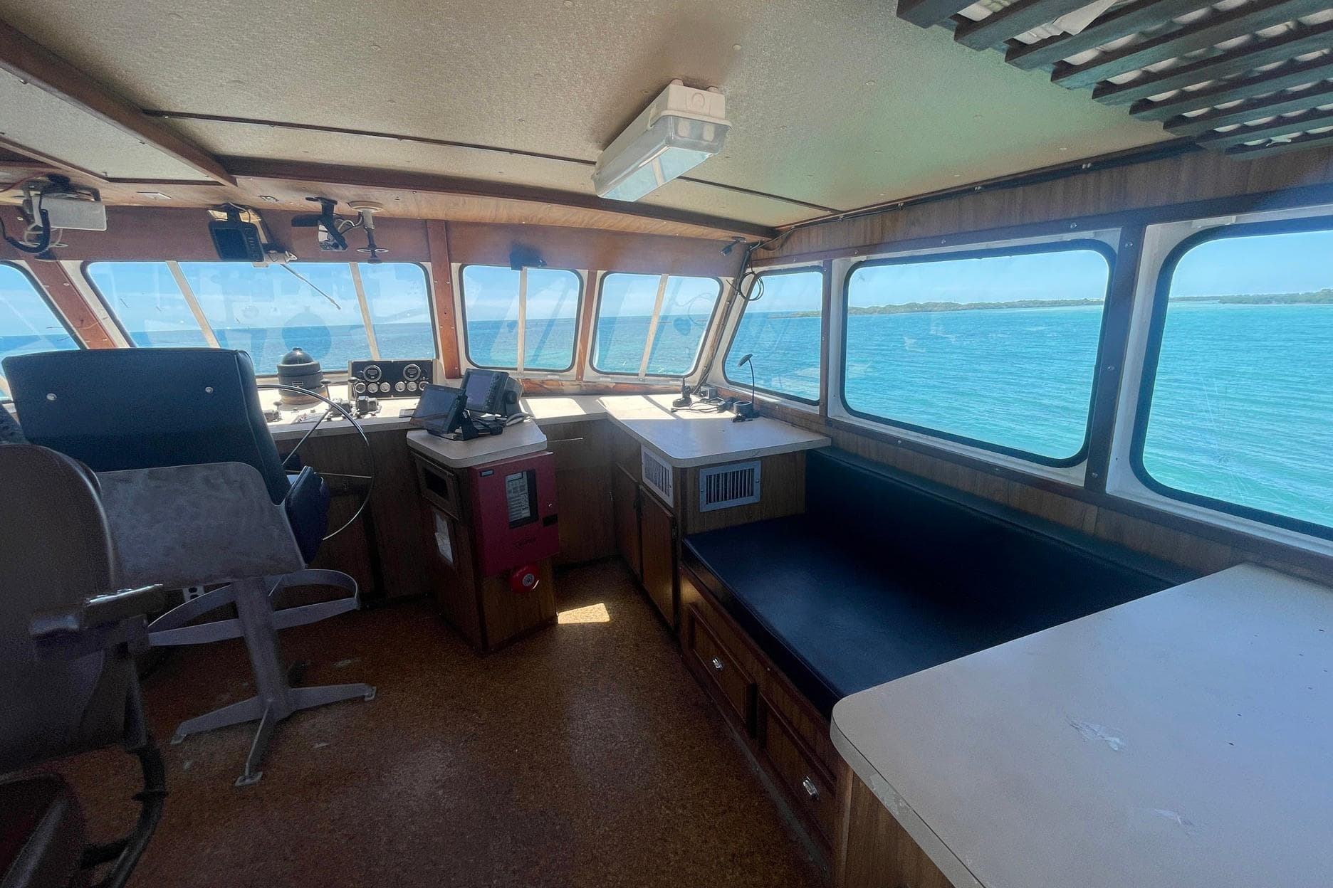 Interior of a 1993 Breaux Brothers Crew Boat with ocean view through large windows.