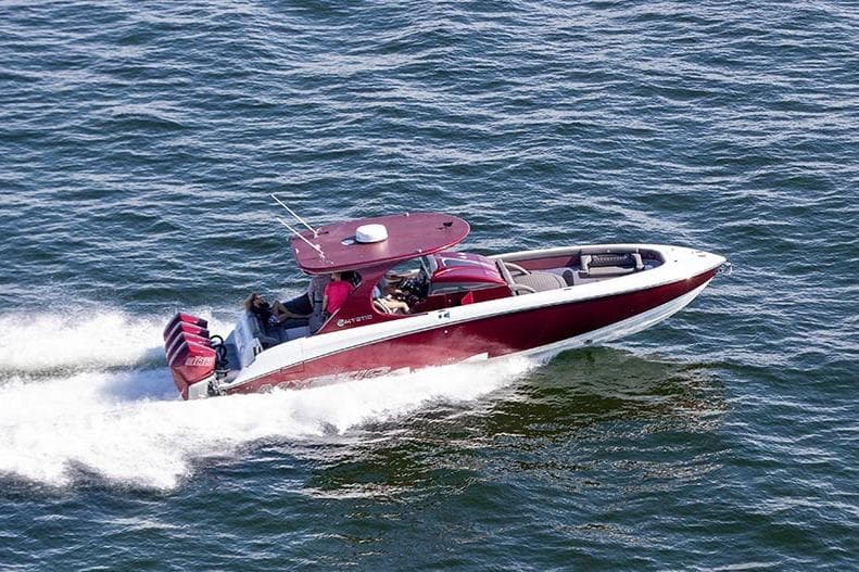 2021 Mystic Powerboats M3800 speeding on open water, showcasing sleek design and performance.