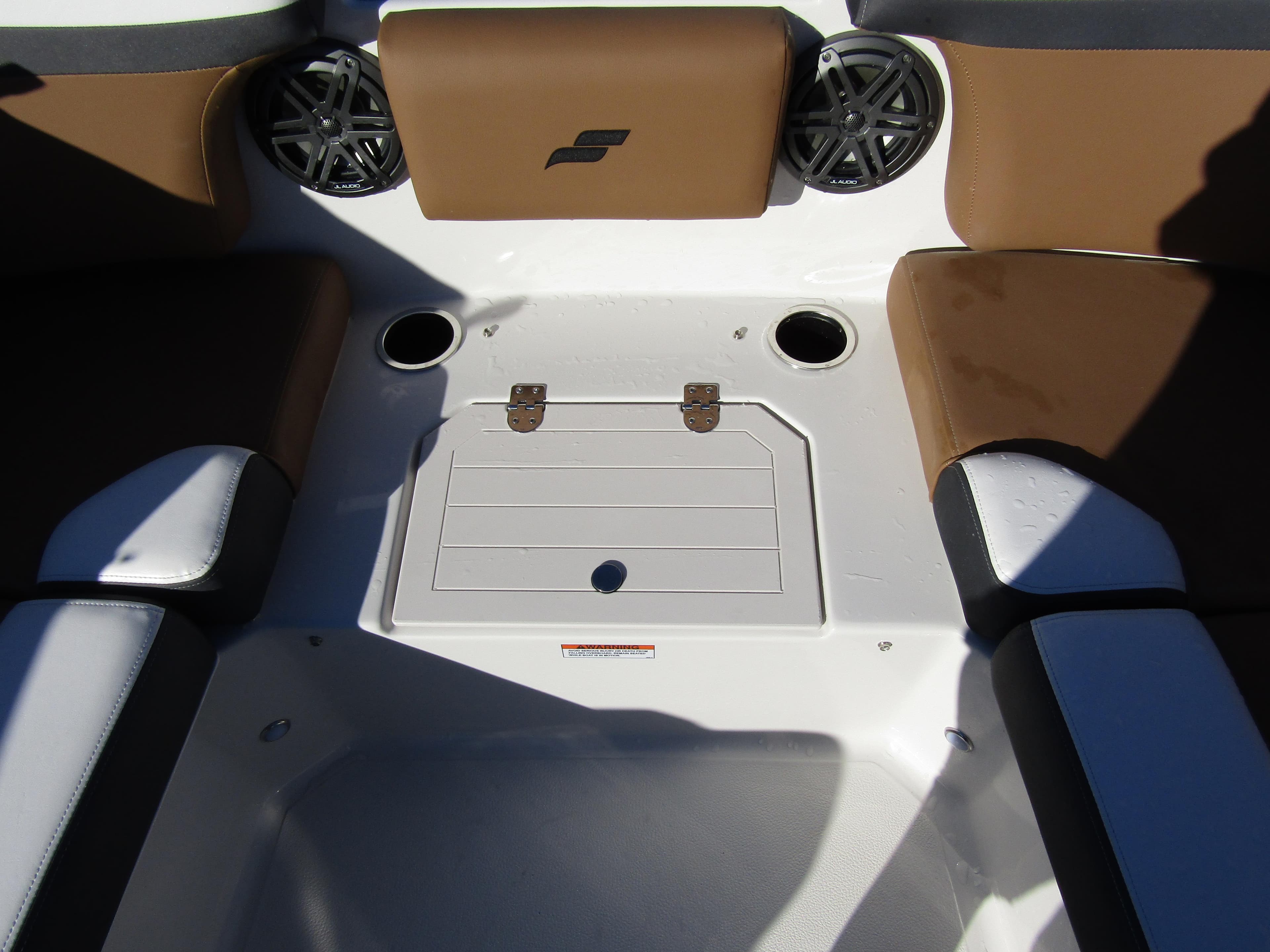 2024 Starcraft SVX 231 OB CC boat seating area with storage compartment and cup holders.