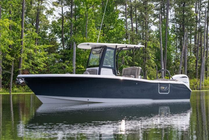 Manufacturer Provided Image: 2026 Sea Hunt Ultra 255 SE boat on a calm lake surrounded by trees.