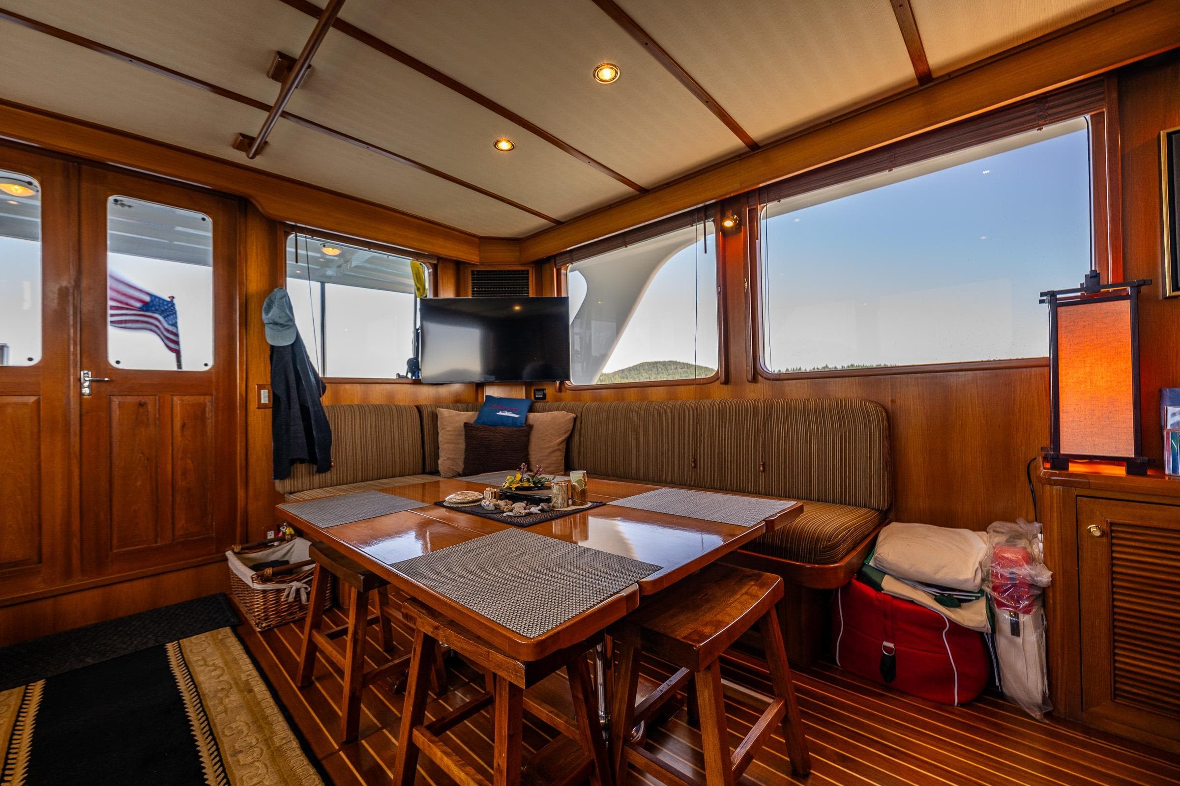 Luxurious 2007 DeFever 56 yacht interior with elegant wood finish and cozy seating area.
