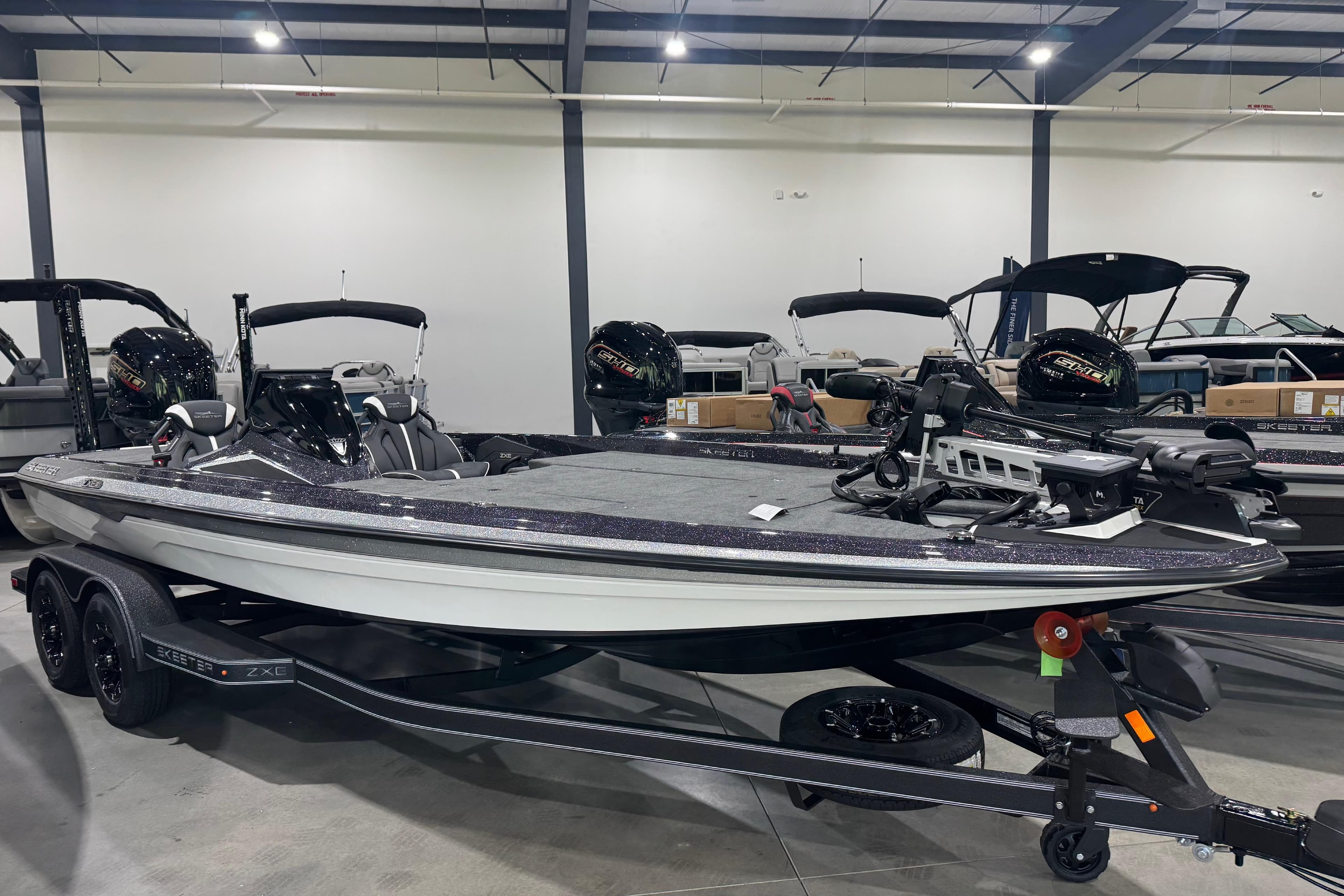 2026 Skeeter ZXE21 bass boat displayed indoors on a trailer.