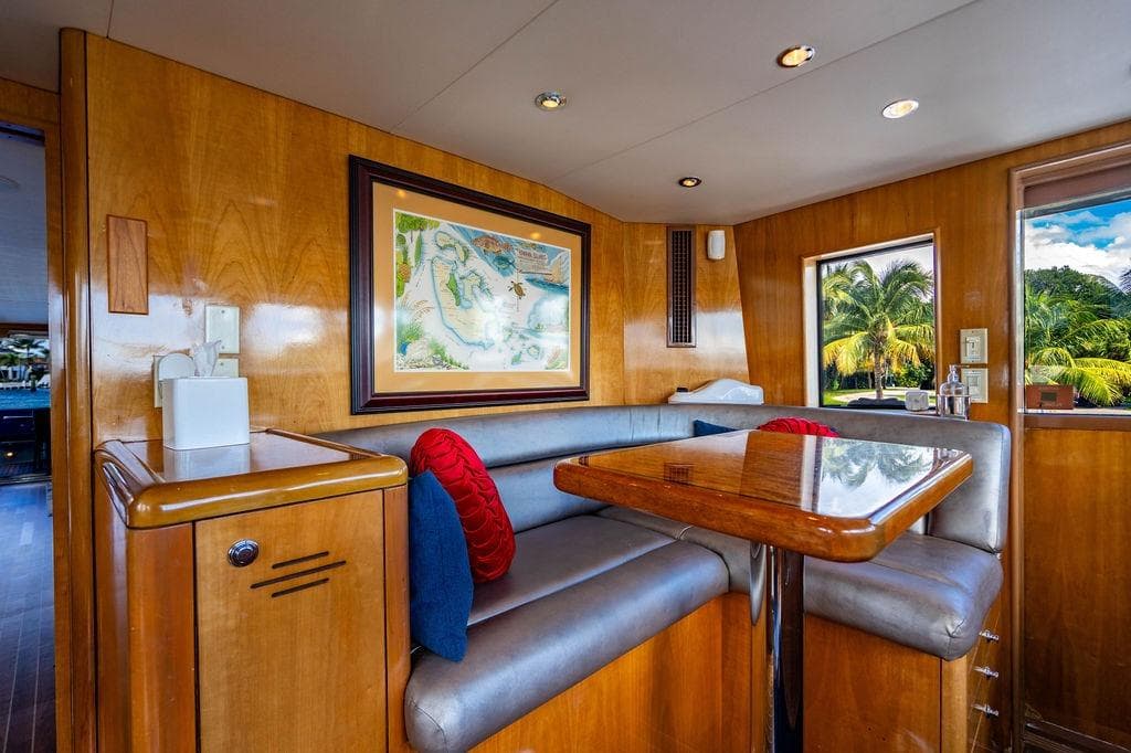 Luxurious interior of 2003 Hatteras 75' Cockpit MY yacht with elegant wood finish.