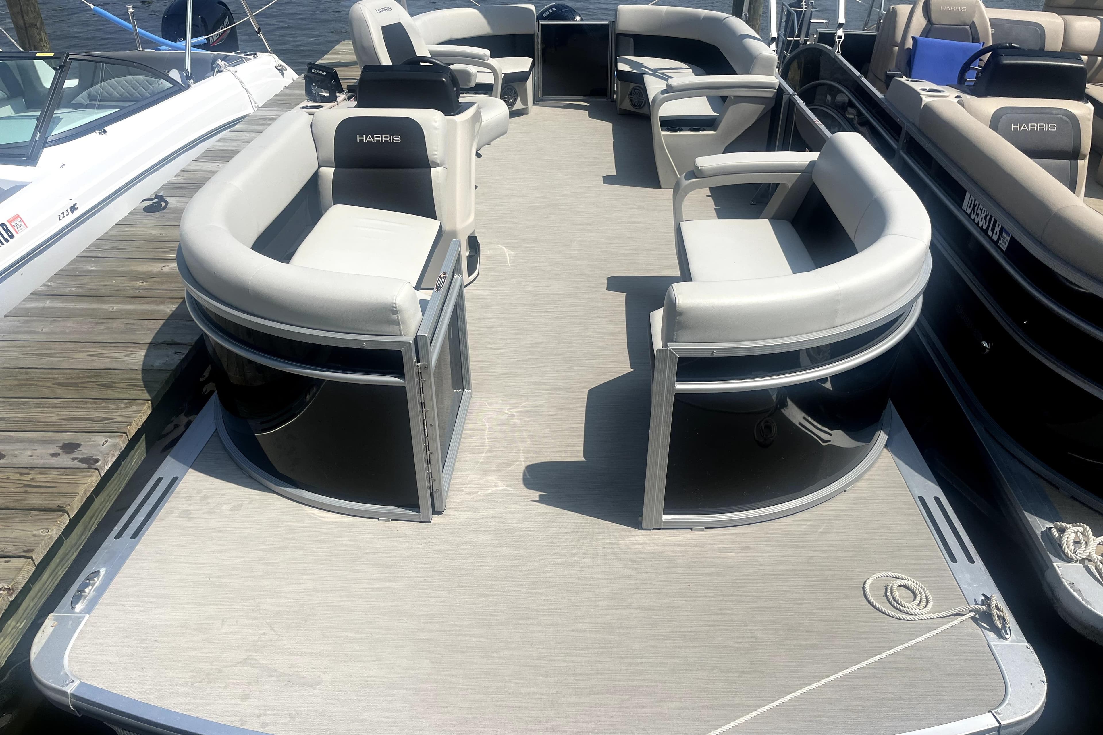 2025 Harris Breeze 230 pontoon boat with spacious seating and modern design.