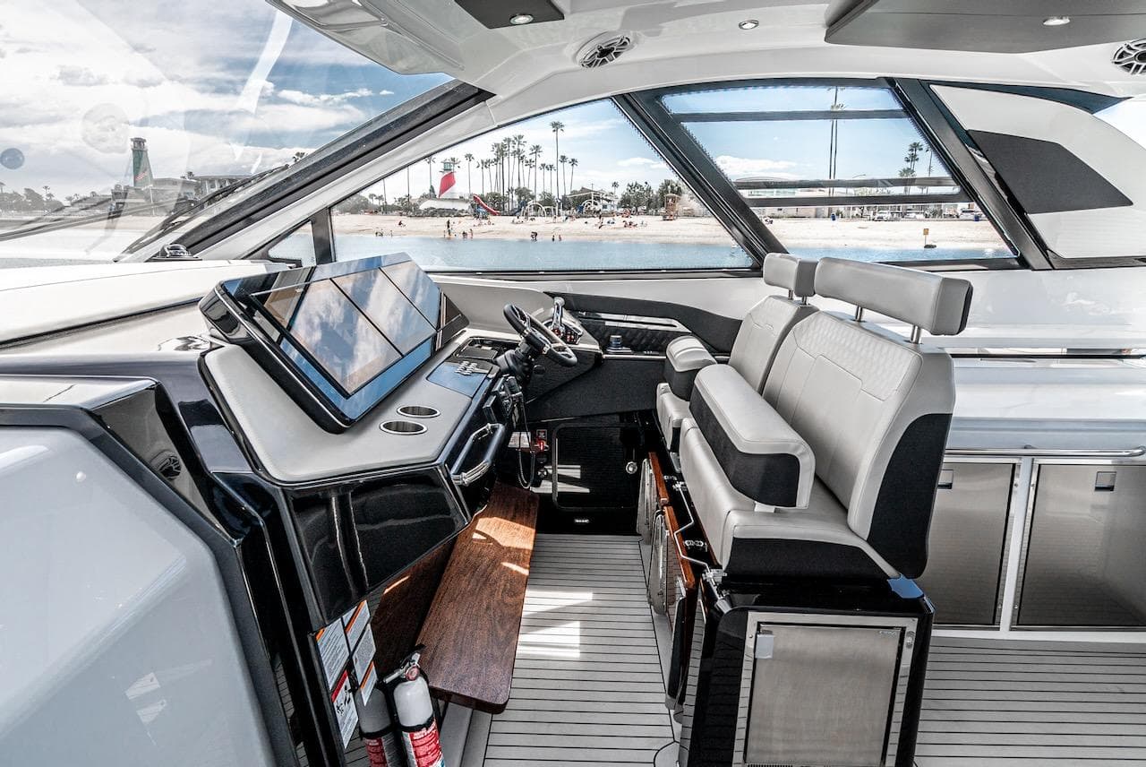 2024 Cruisers Yachts 50 GLS helm station with modern navigation equipment and luxurious seating.