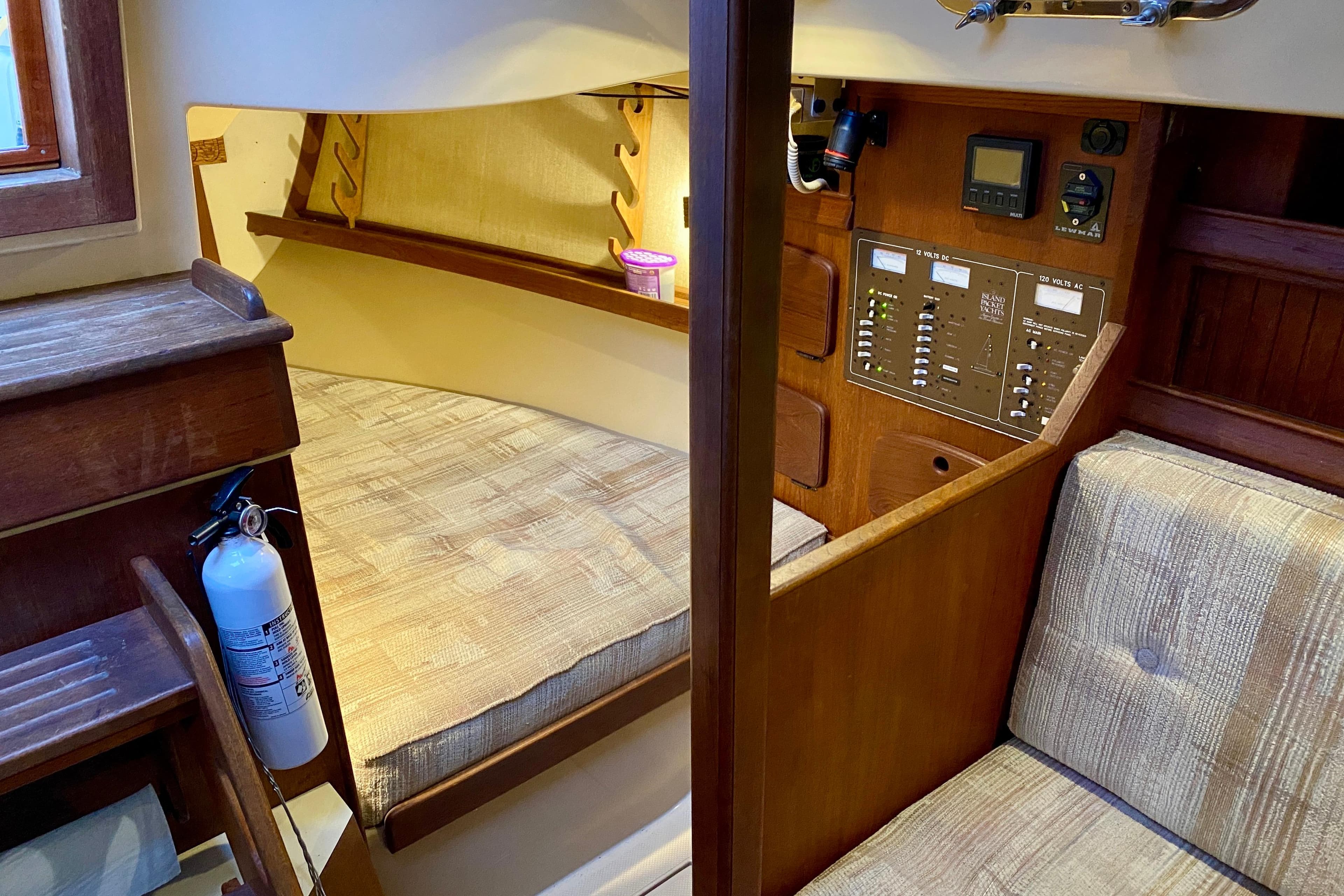 Interior of a 1992 Island Packet 29 sailboat, featuring a cozy cabin and control panel.