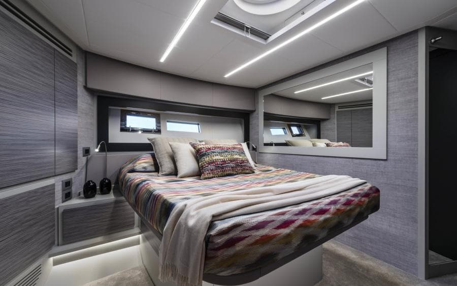Luxurious 2024 Pershing 6X yacht bedroom with modern design and ambient lighting.