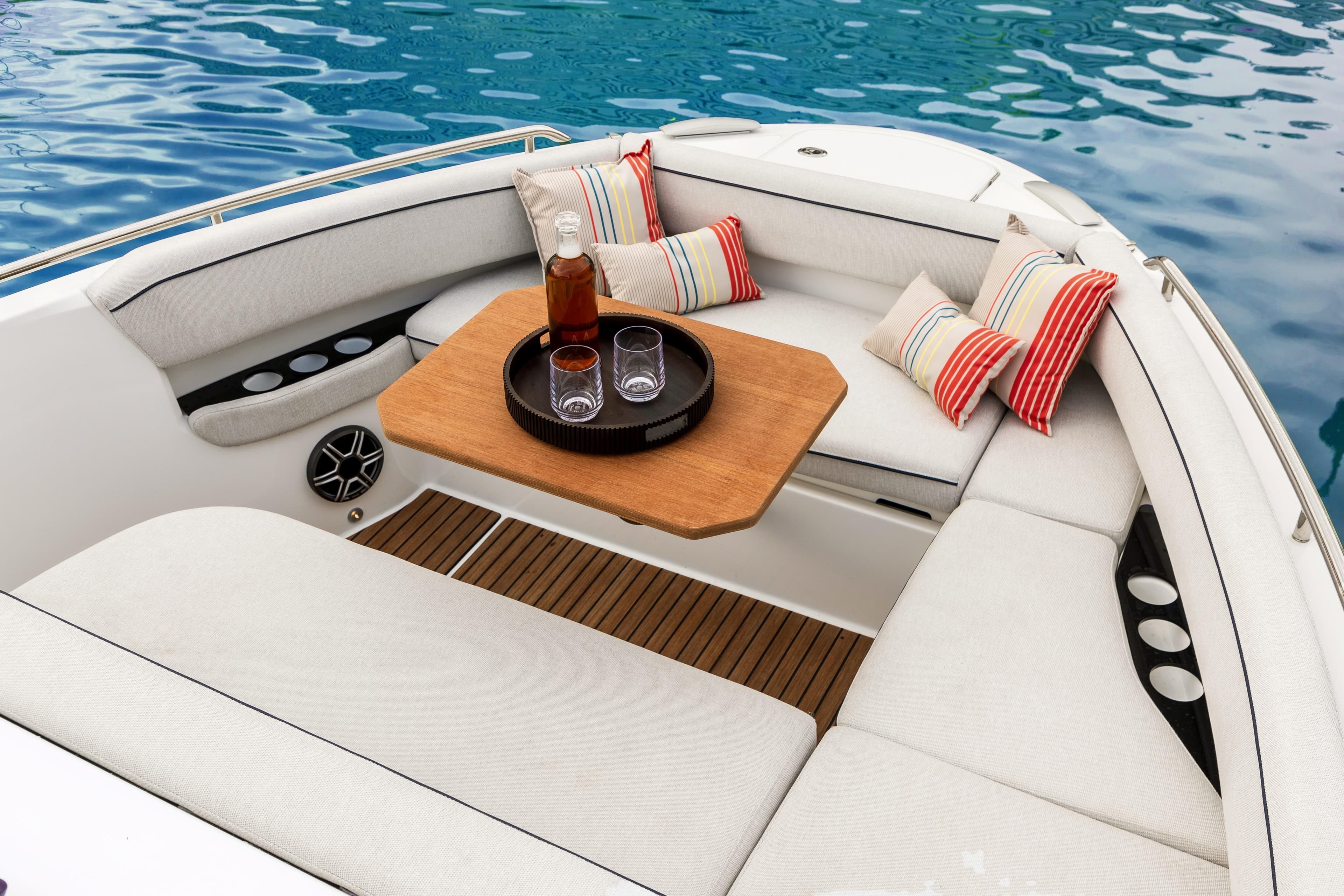 2026 Beneteau Gran Turismo 35 boat interior with cozy seating and striped cushions.