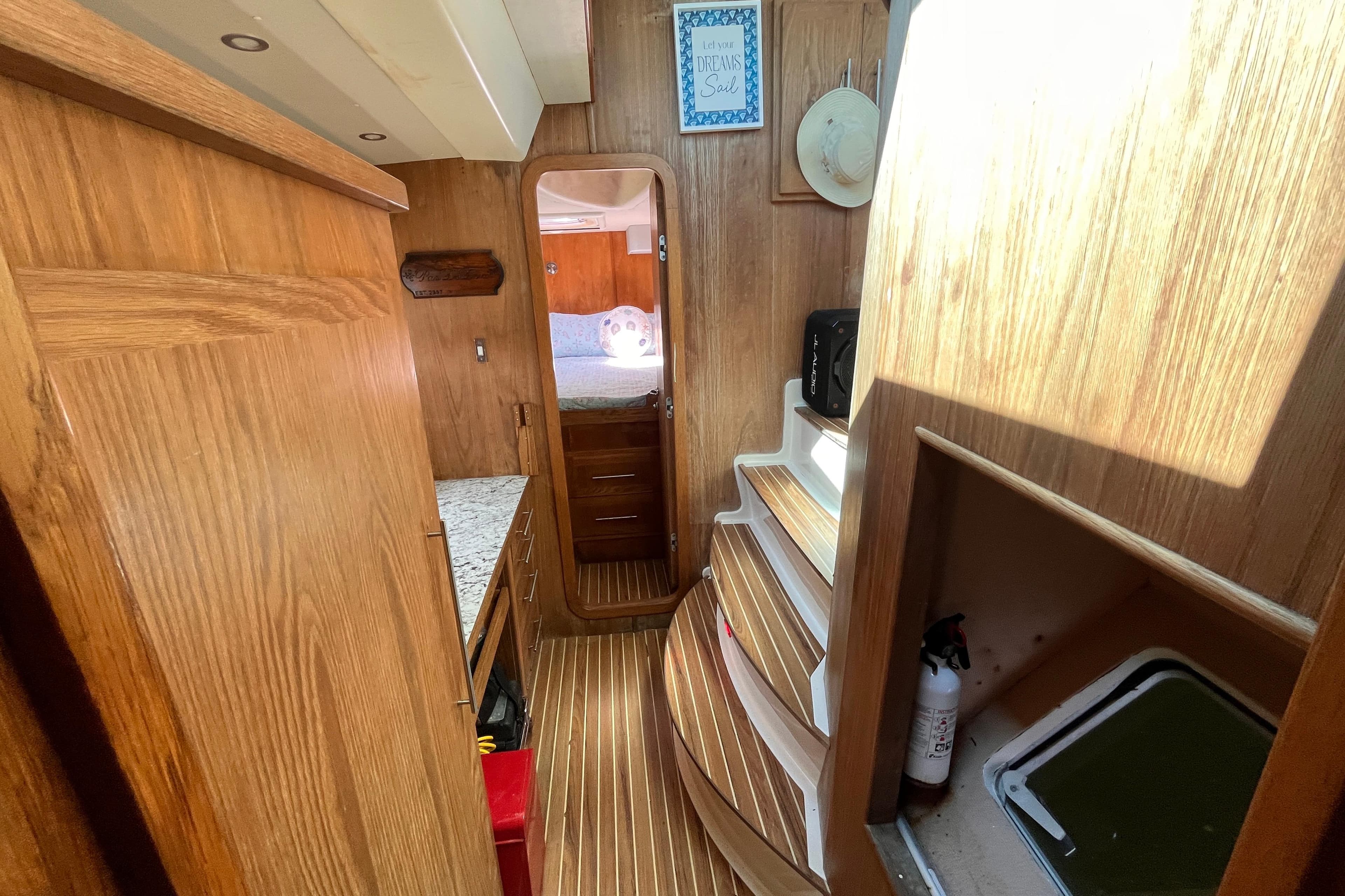 Interior of 2008 Broadblue 415 yacht with wooden cabinetry and cozy sleeping area.