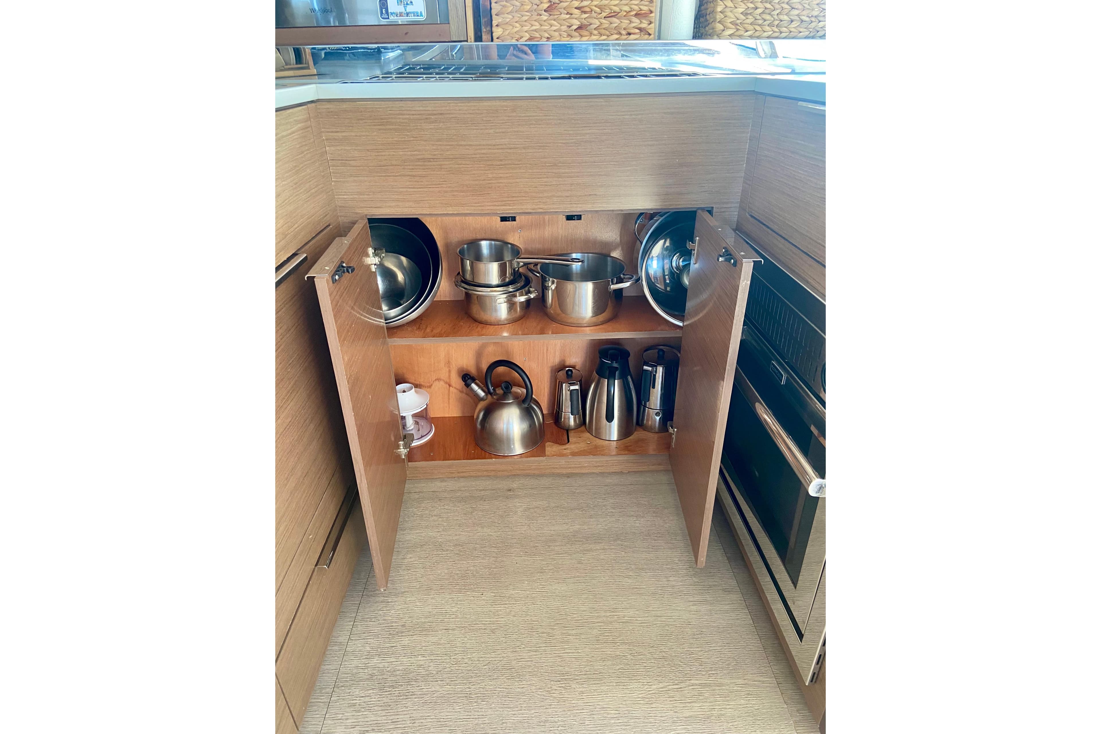 2020 Lagoon 46 yacht kitchen cabinet with cookware and appliances.