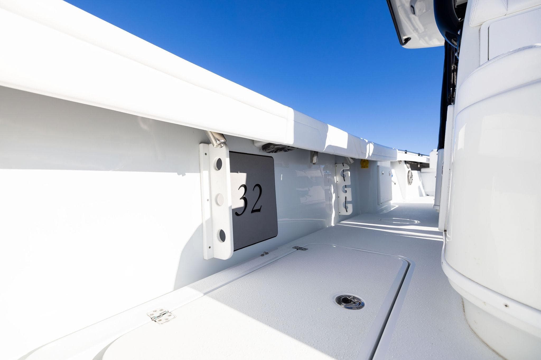 2023 Yellowfin 32 Offshore boat interior with sleek white deck and clear blue sky.