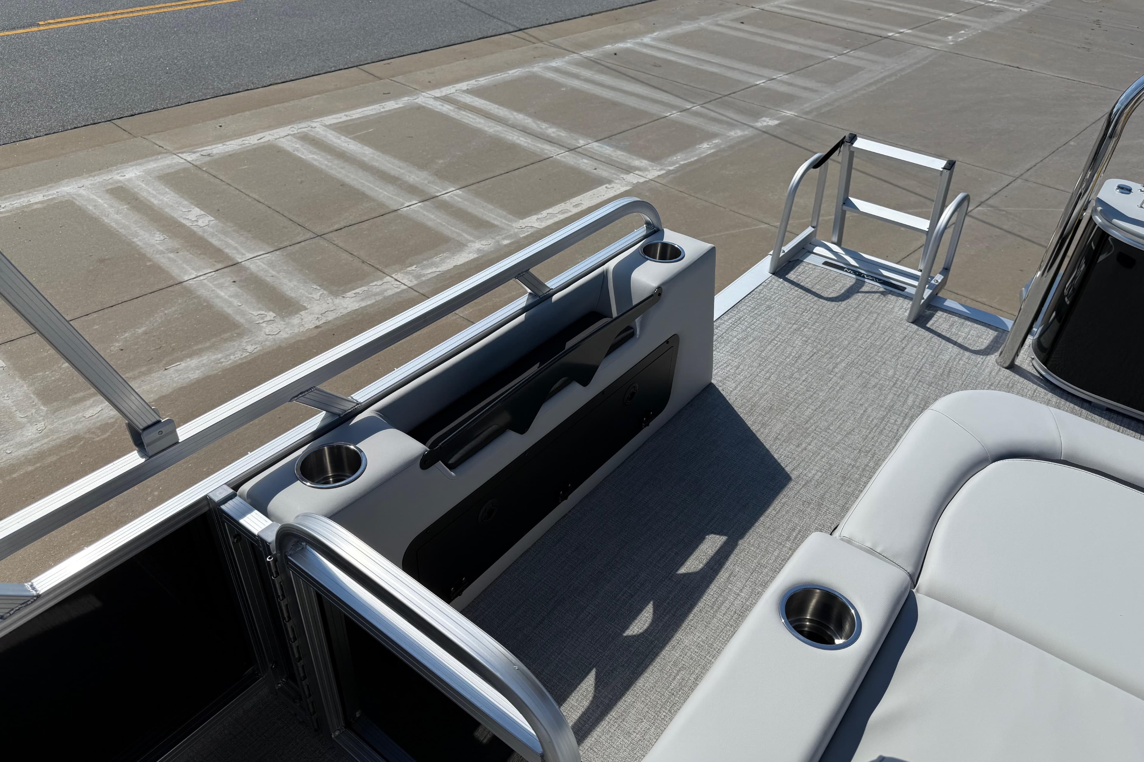 2026 Avalon Venture 85 Versatile rear bench with cup holders and ladder on a boat deck.