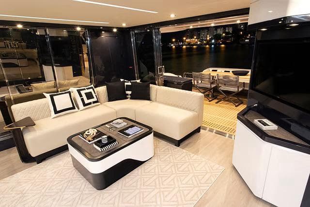 Luxurious interior of 2026 Schaefer 770 yacht with modern furnishings and waterfront view.