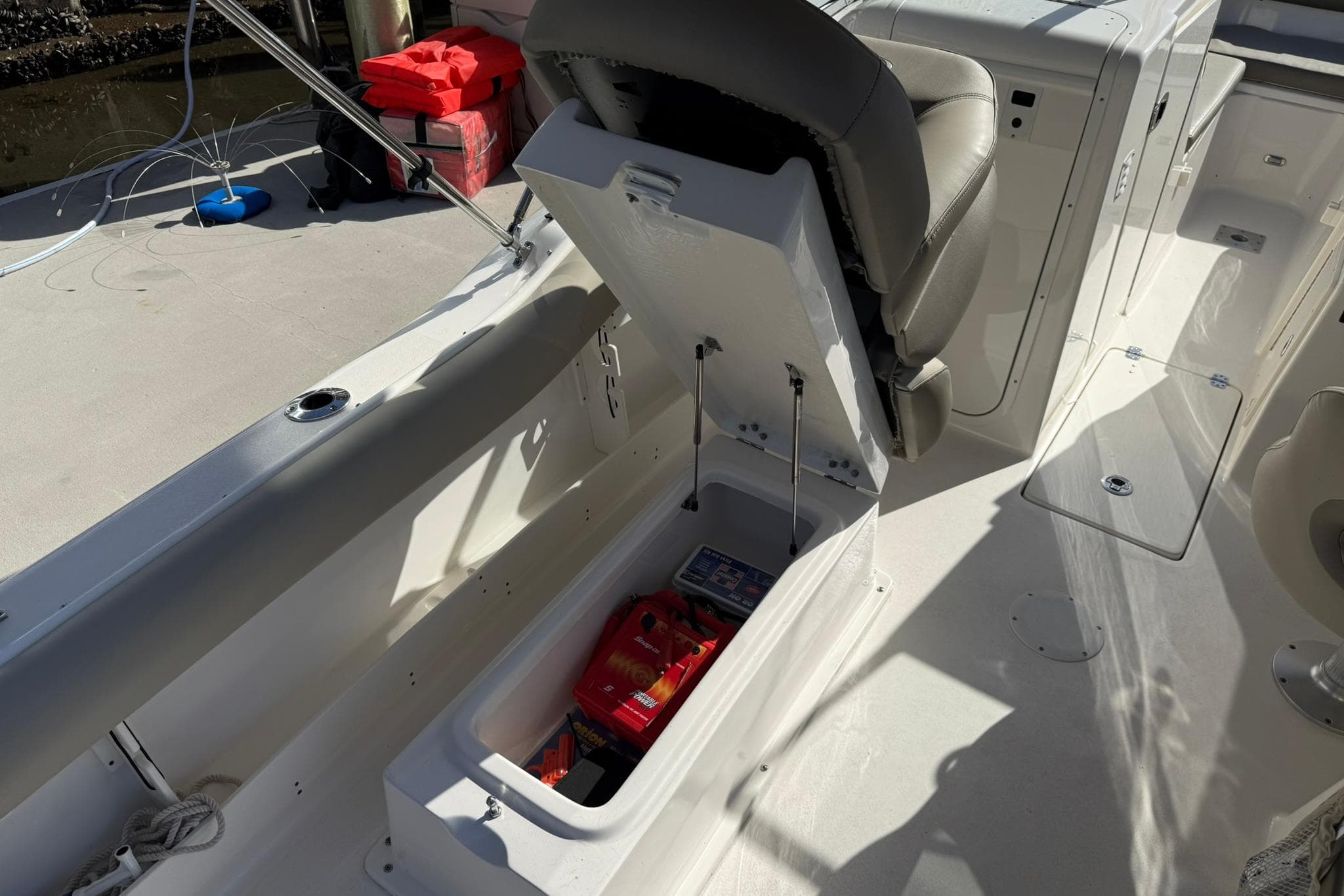 2023 Key West 239 DFS boat interior with open storage compartment and seat.
